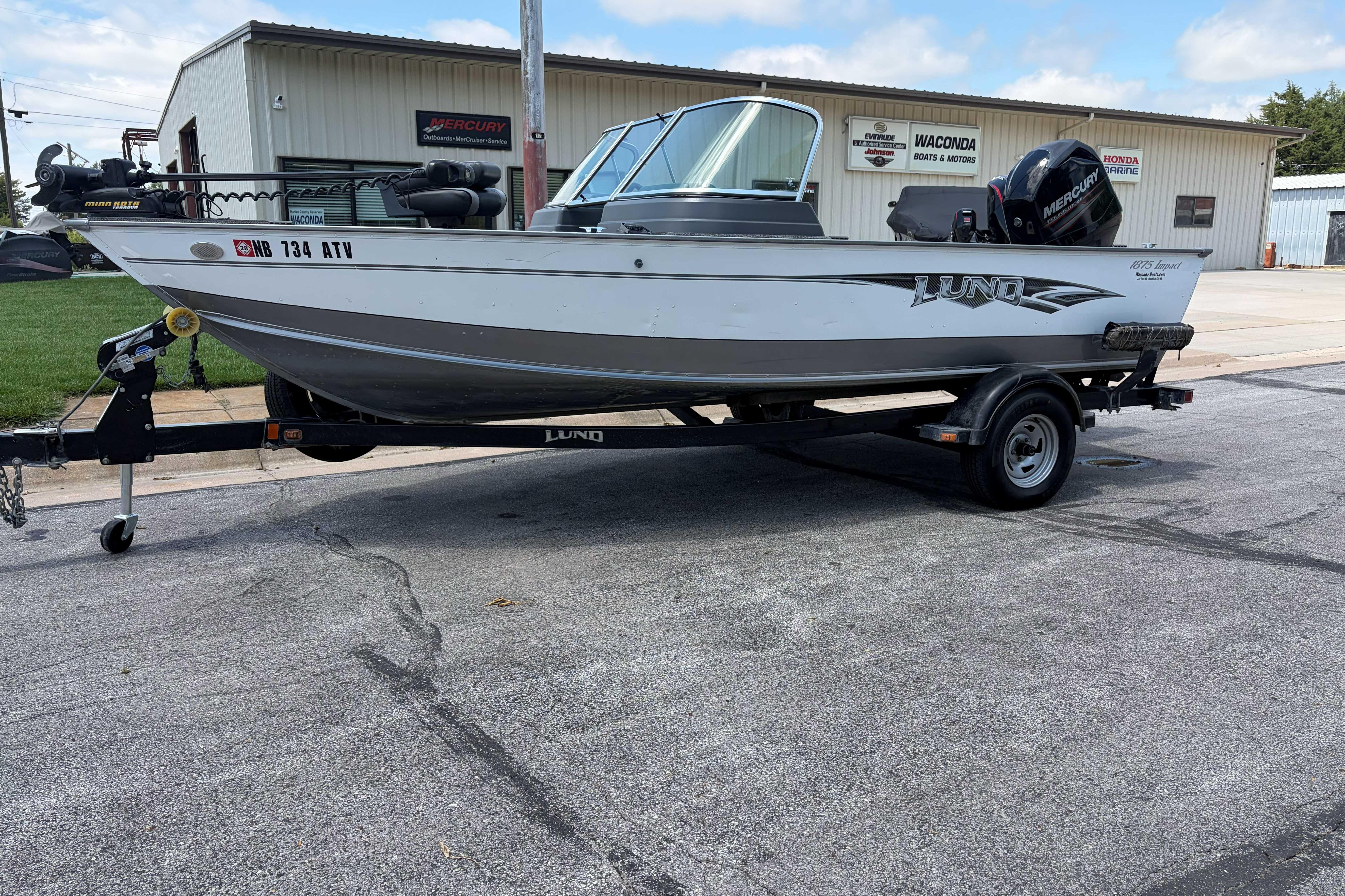 2014 Lund 1875 Impact XS boat on trailer outside dealership.