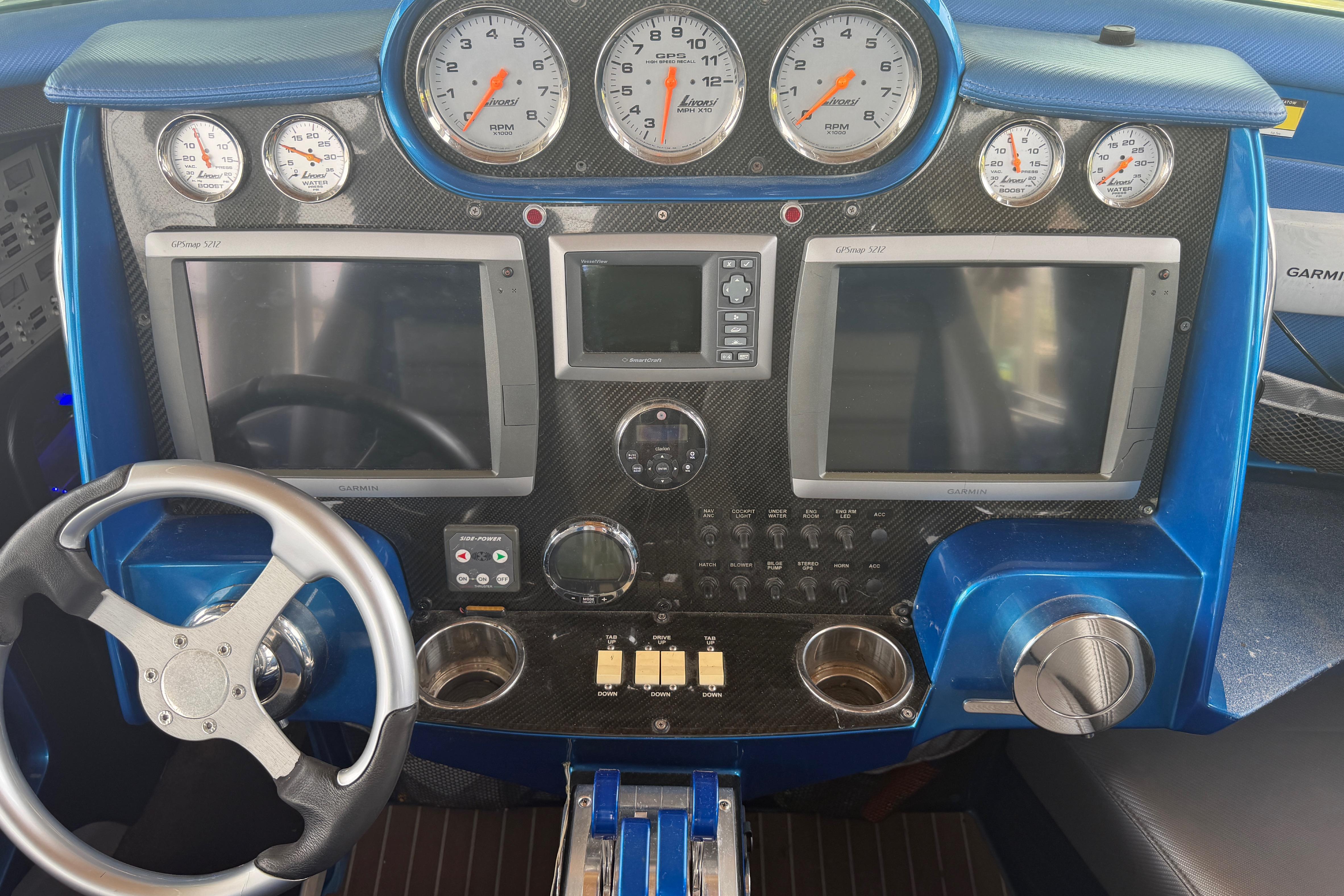 Dashboard of a 2013 Nor-Tech 477 SPX Vee Bottom boat with gauges and navigation screens.