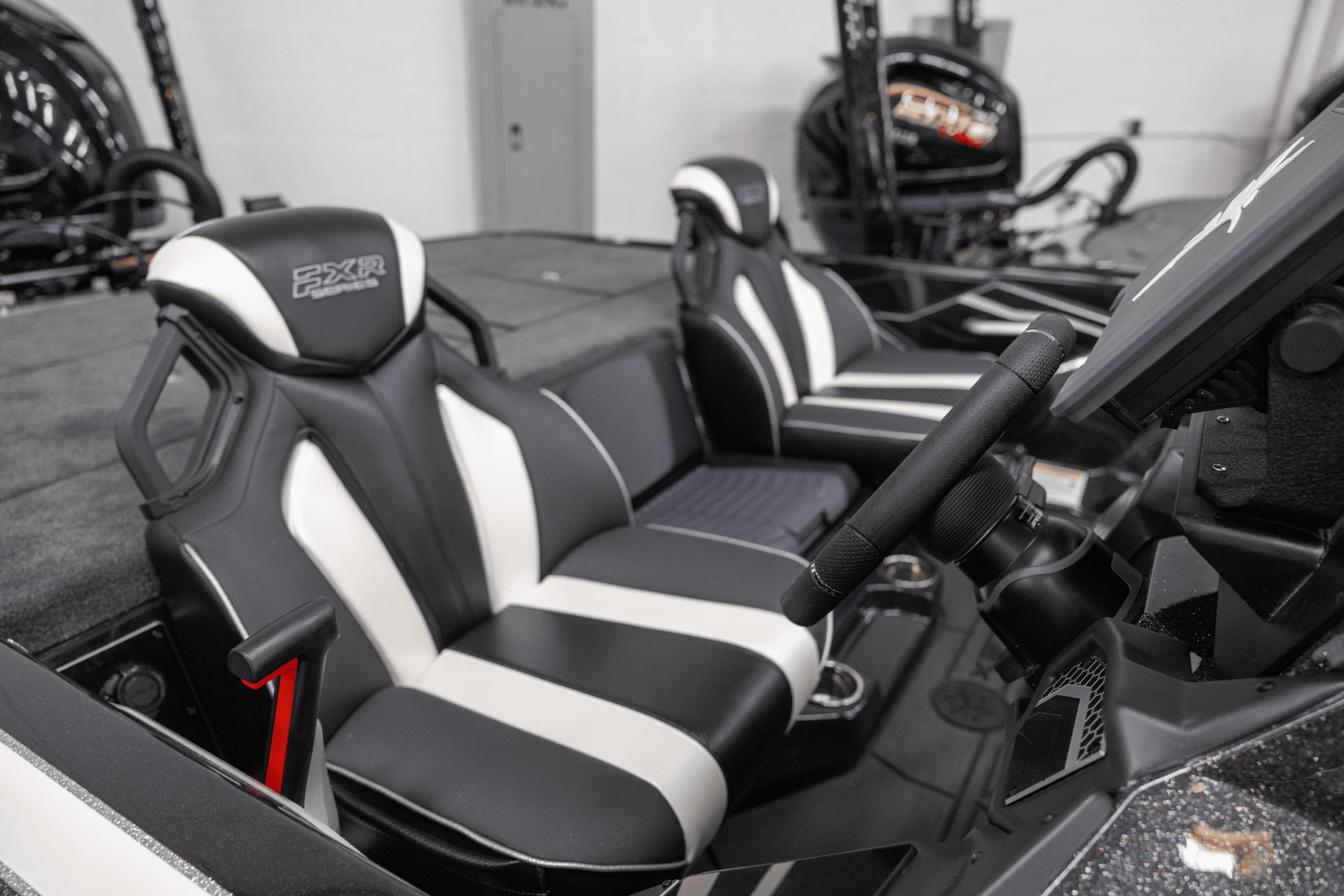 2026 Skeeter FXR21 FLEX boat interior with black and white seats and steering console.