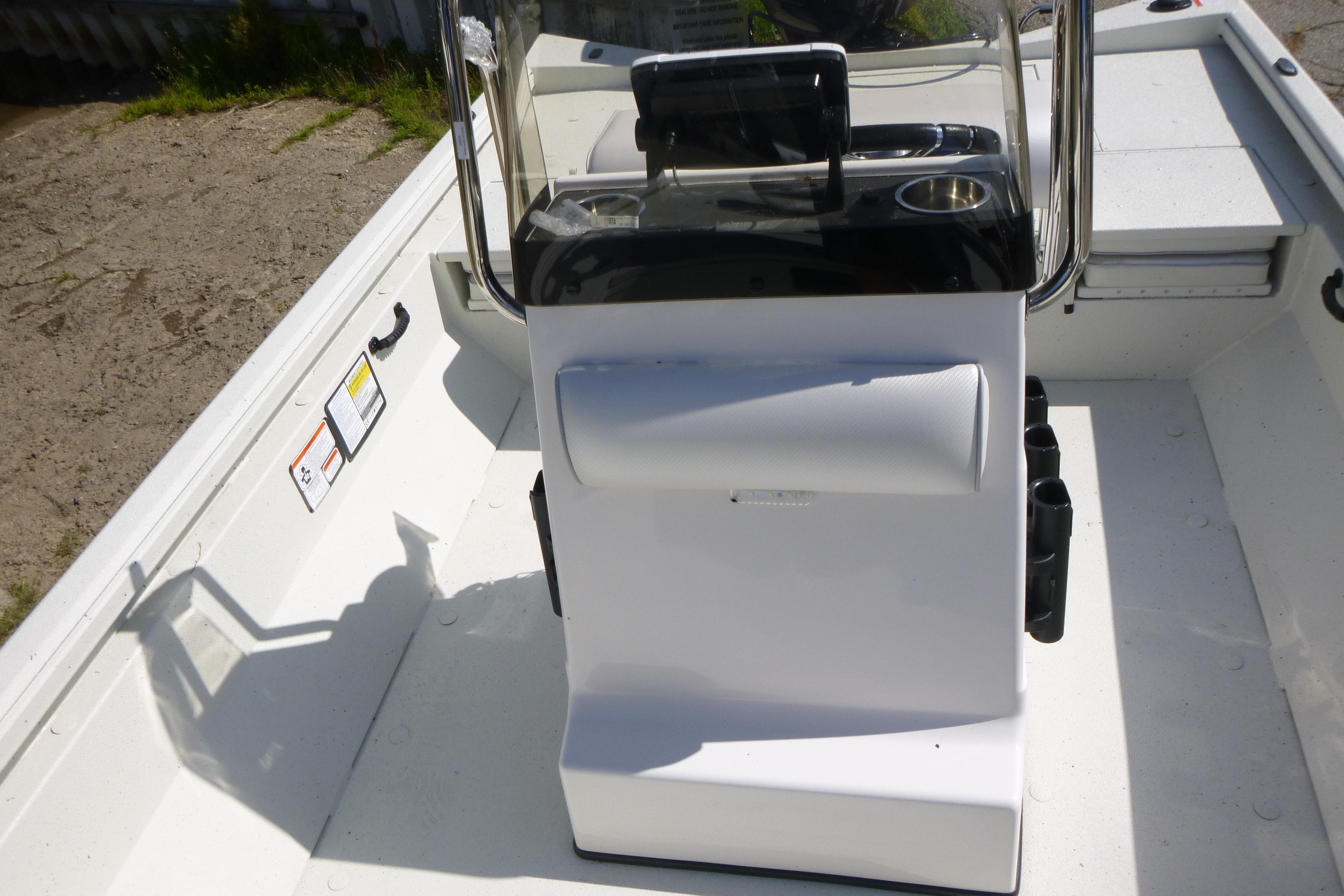 2025 Ranger RB210 boat console with steering wheel and controls, docked on a sunny day.