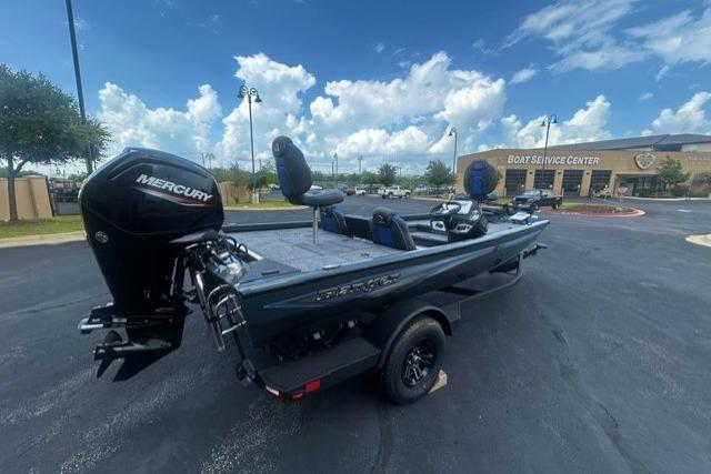 2026 Ranger RT178 boat with Mercury engine at a service center under a blue sky.