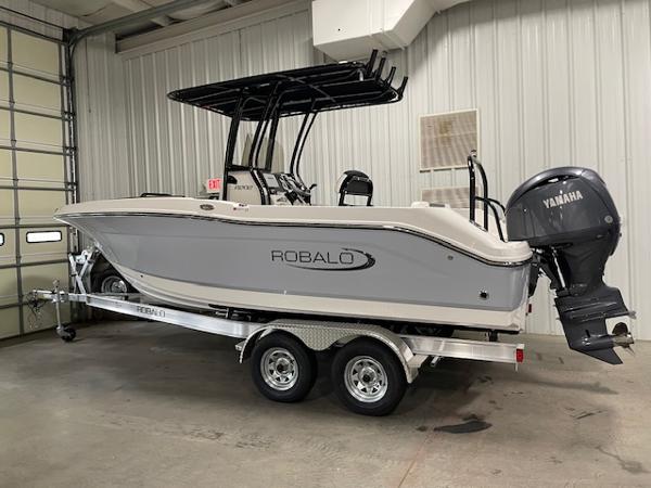 2025 Robalo R202 Explorer boat with Yamaha engine on trailer in garage.