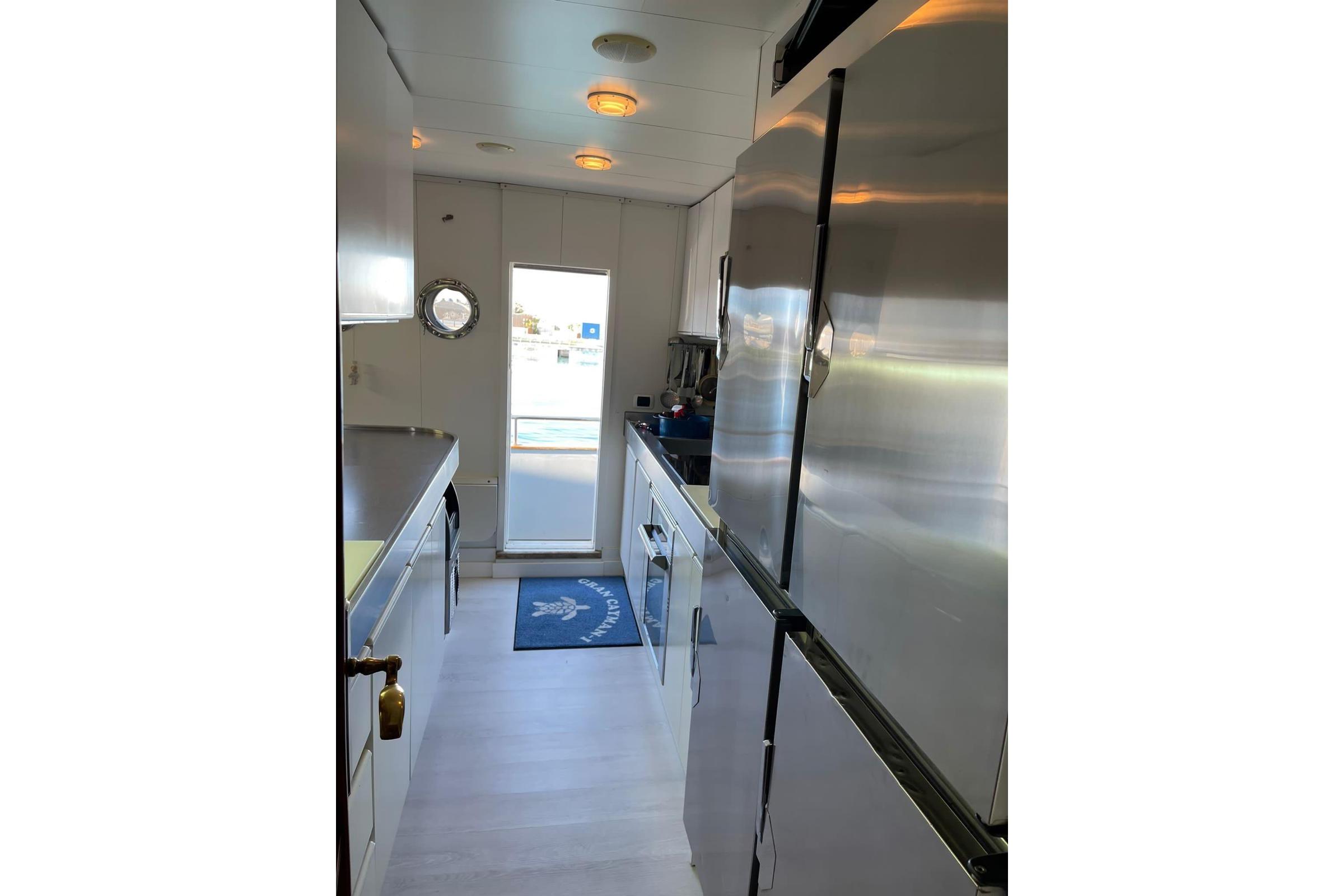 Interior of 1985 Astondoa 24 yacht kitchen with modern appliances and sleek design.