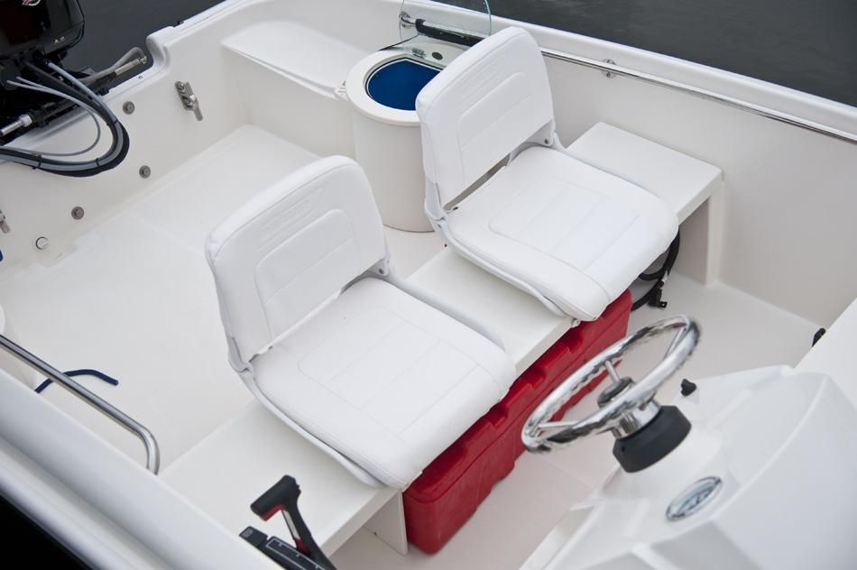 Interior of a 2018 Boston Whaler 150 Super Sport boat with white seats.