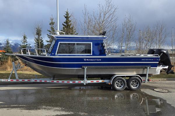 2024 Spartan 26 Maximus Pro XL boat on trailer, parked outdoors.