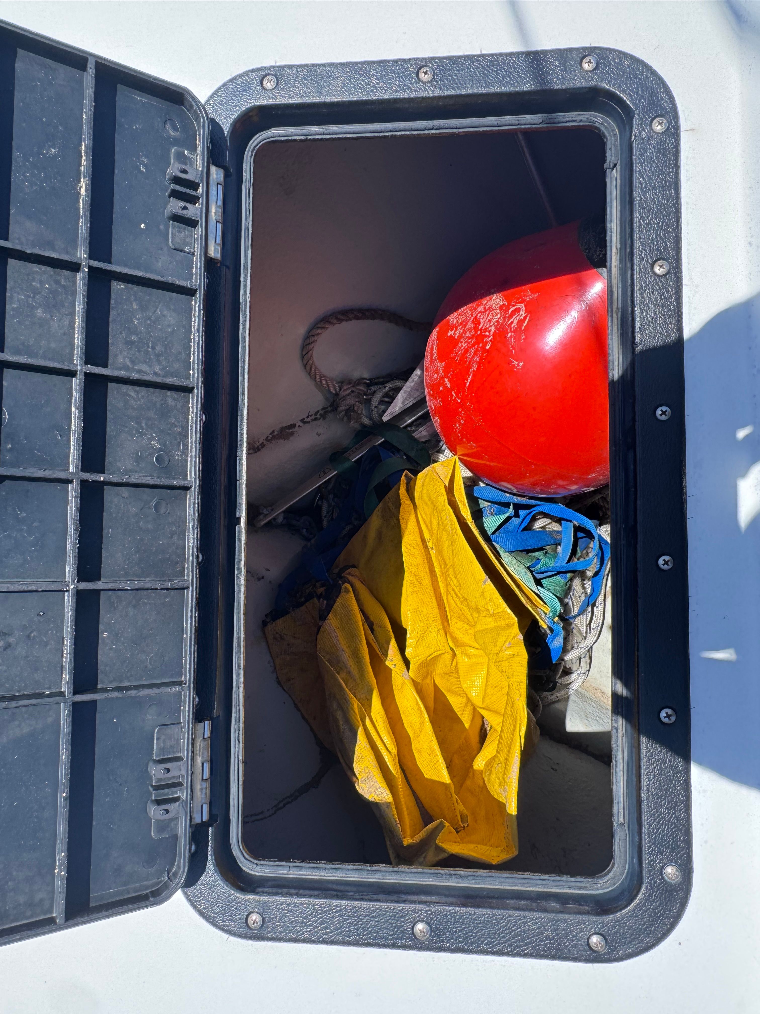 Open storage compartment on 1998 Dusky 20.3 boat with gear.