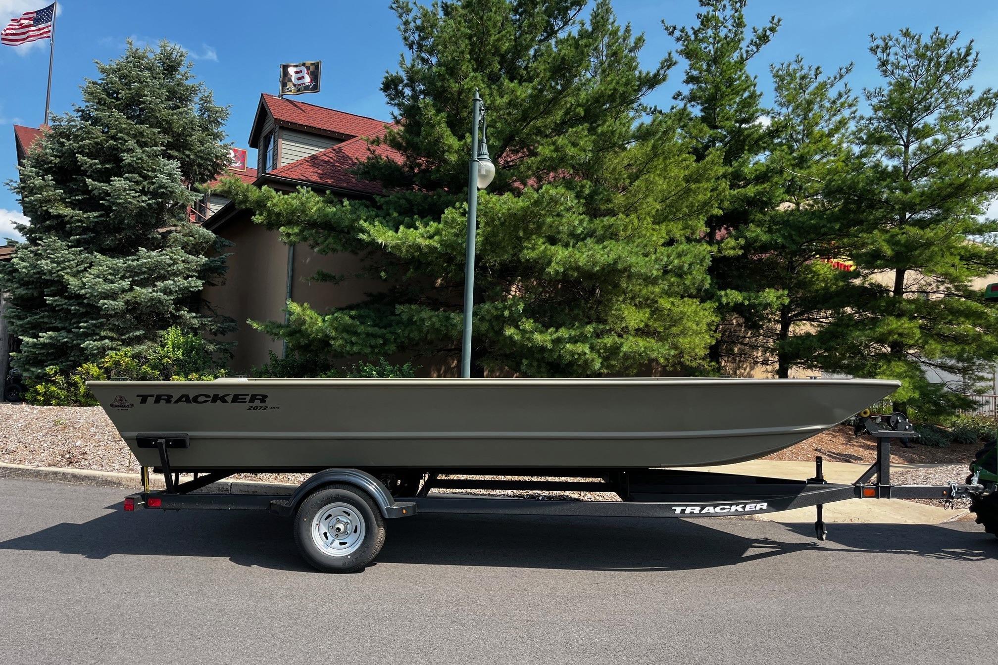 2026 Tracker GRIZZLY 2072 Utility boat on trailer, parked outdoors.