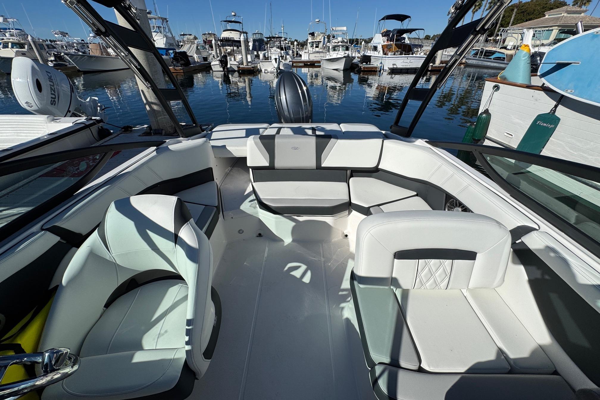 2026 Regal 21 OBX boat interior with white seating, docked at a marina.
