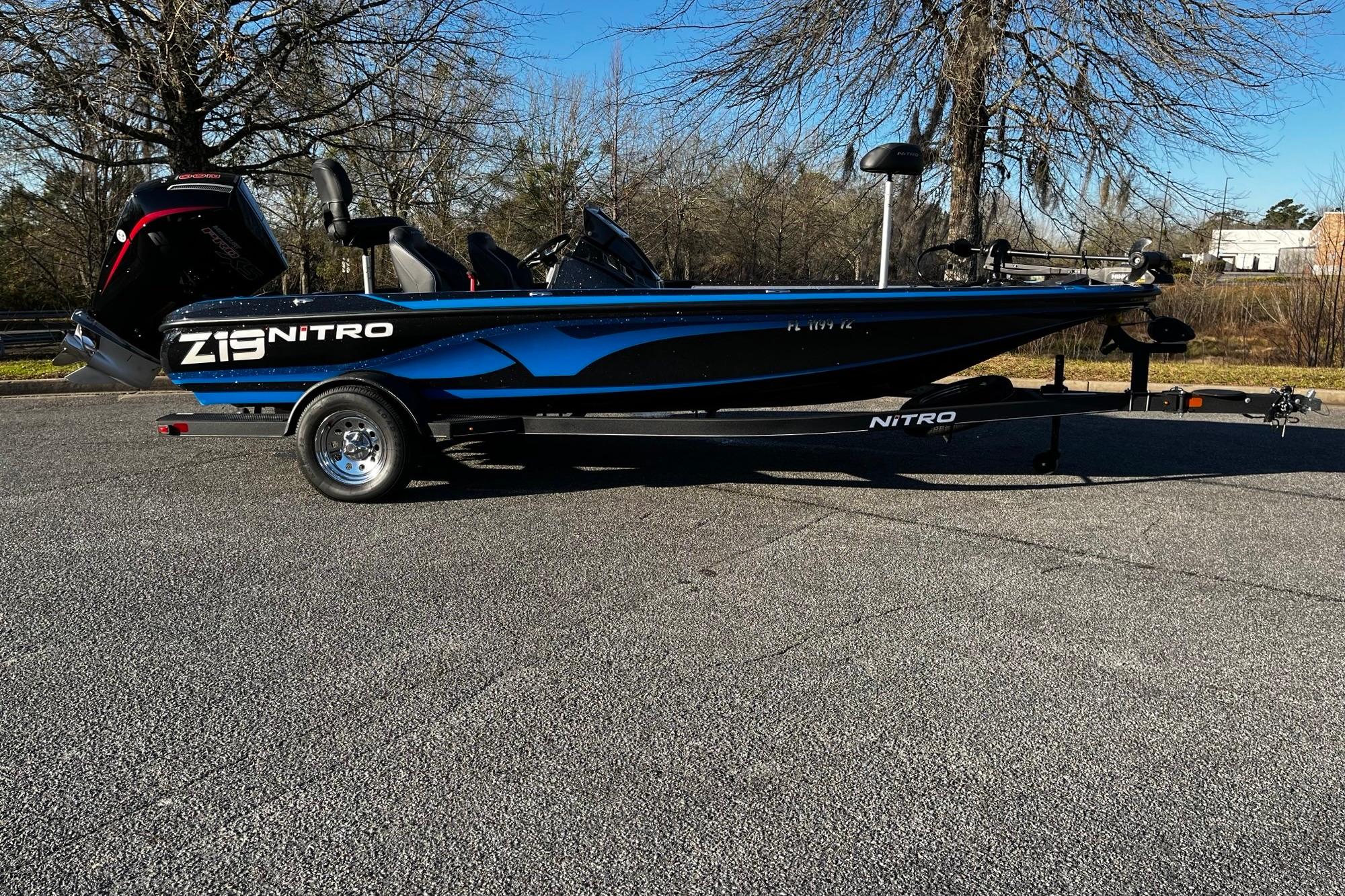 2024 Nitro Z19 boat with trailer, parked outdoors on a sunny day.