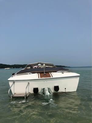 A 1972 Chris-Craft XK-19 on calm water with a clear view of the stern.