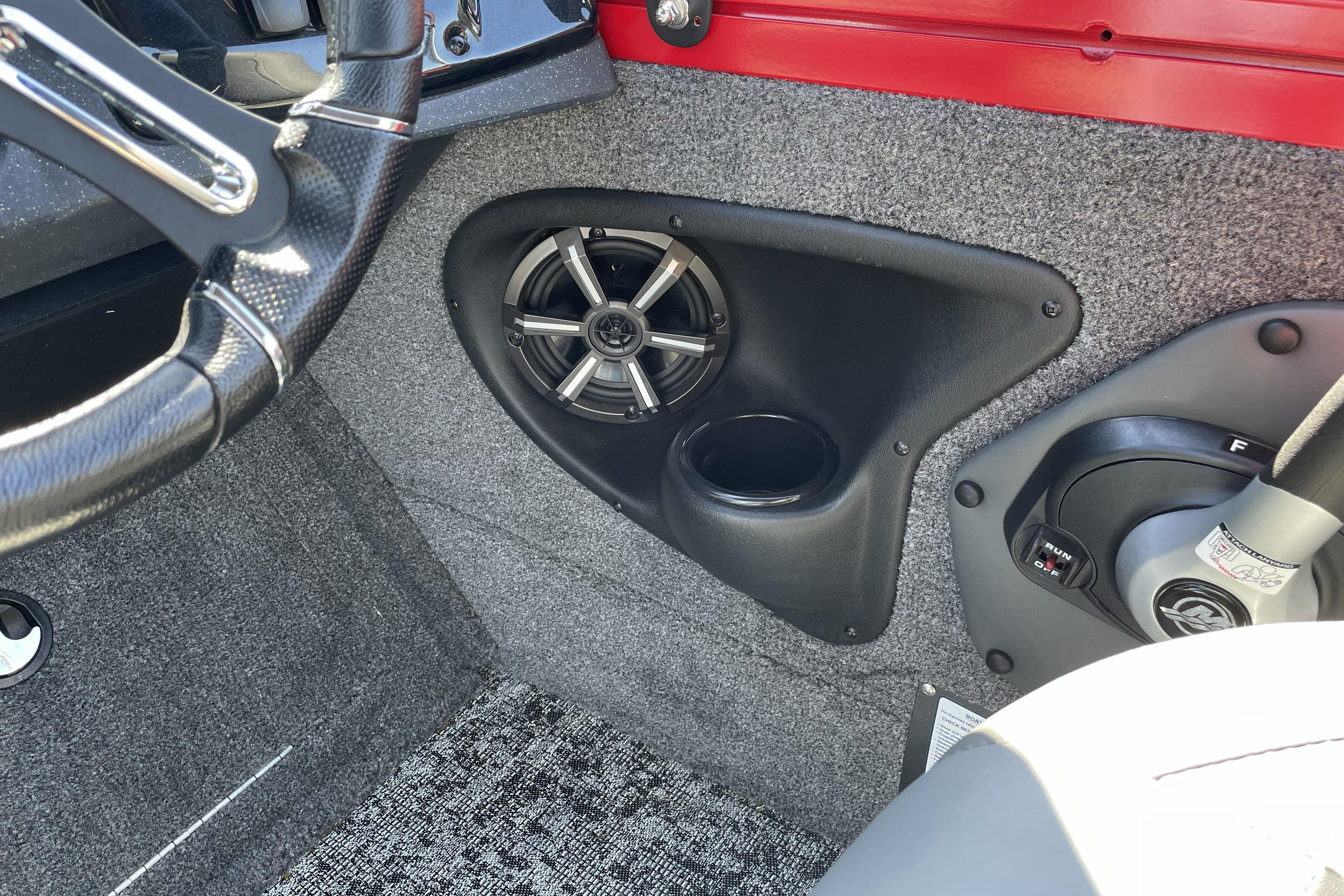 Interior of 2026 Tracker Targa V-18 WT boat showing steering wheel and speaker.