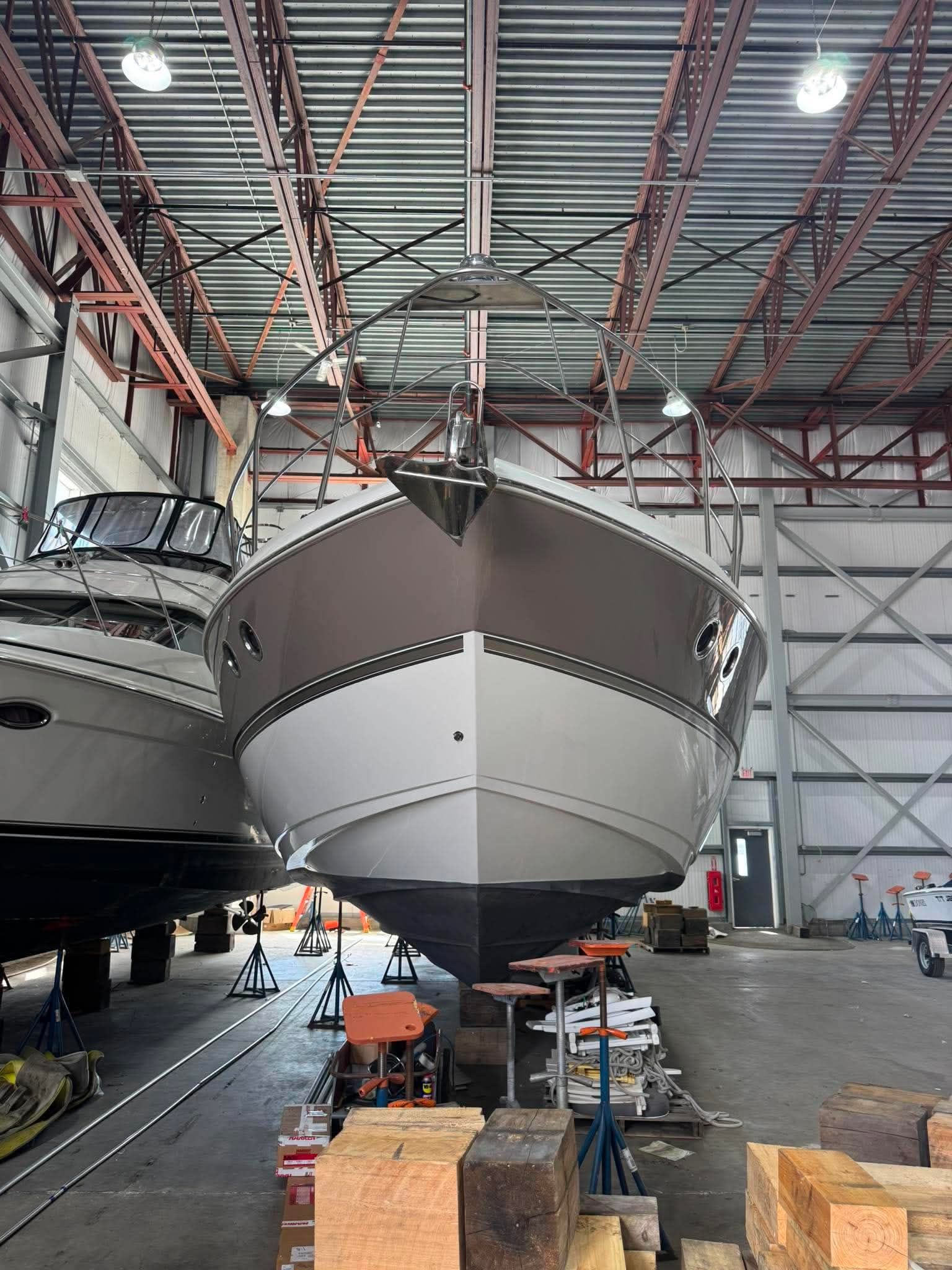 A 2009 Cruisers Yachts 520 Sports Coupe is on stands in a storage facility.