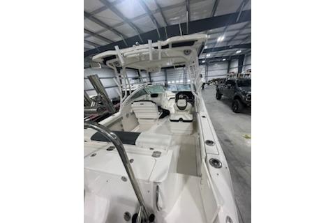 2022 Robalo R247 Dual Console boat in a spacious indoor showroom.