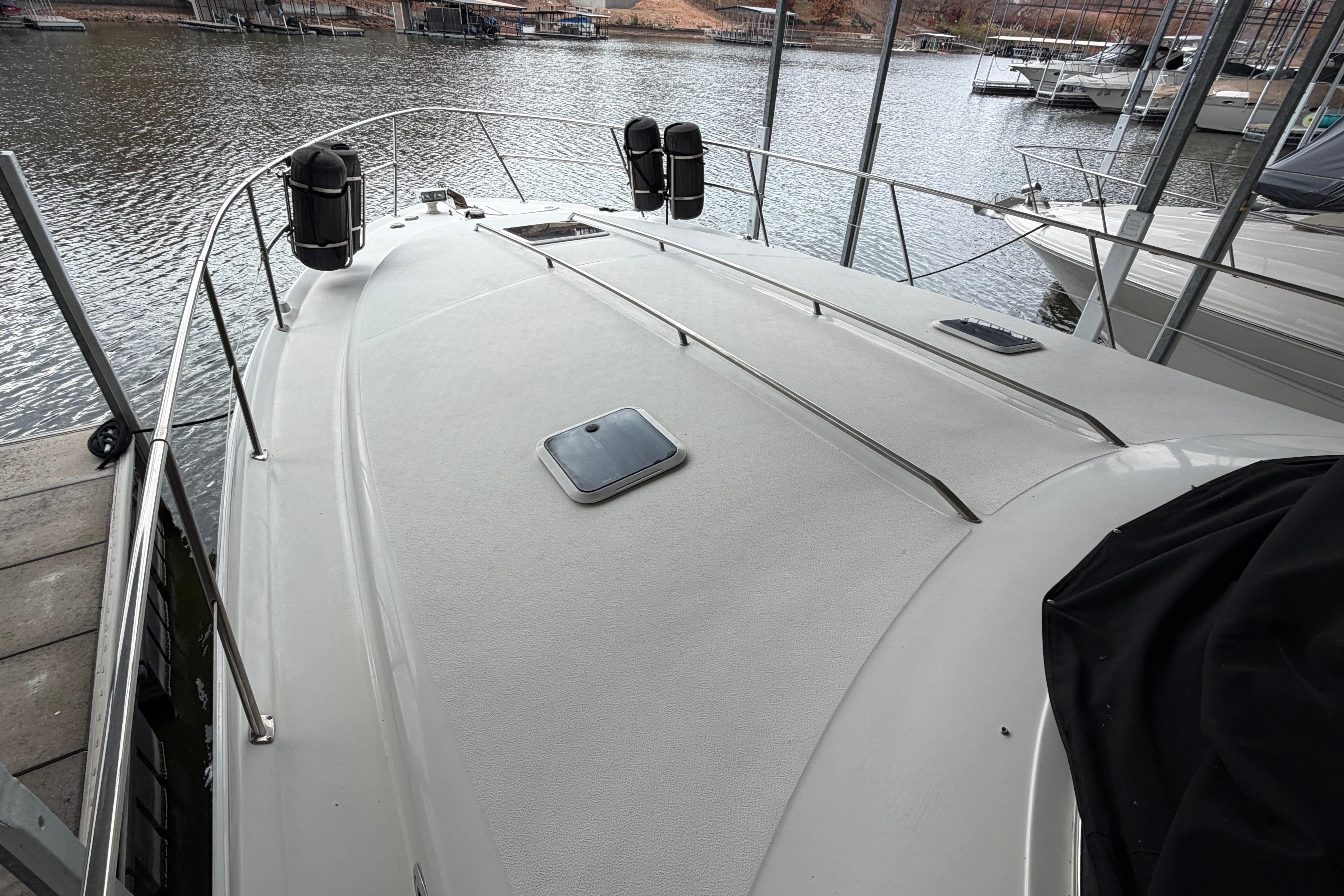 1999 Sea Ray 400 Sundancer yacht docked, showcasing spacious deck and sleek design.
