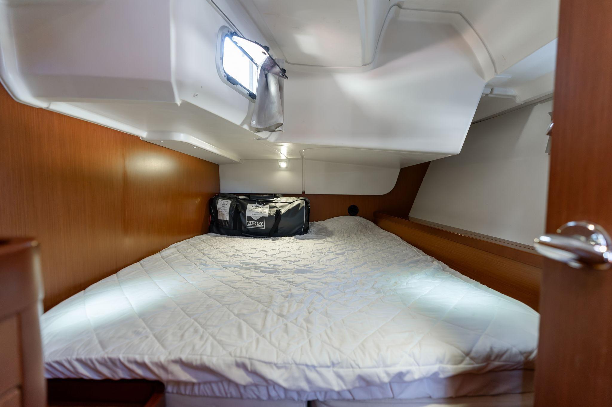 Cozy cabin interior of 2013 Beneteau Oceanis 50 sailboat with comfortable bedding.