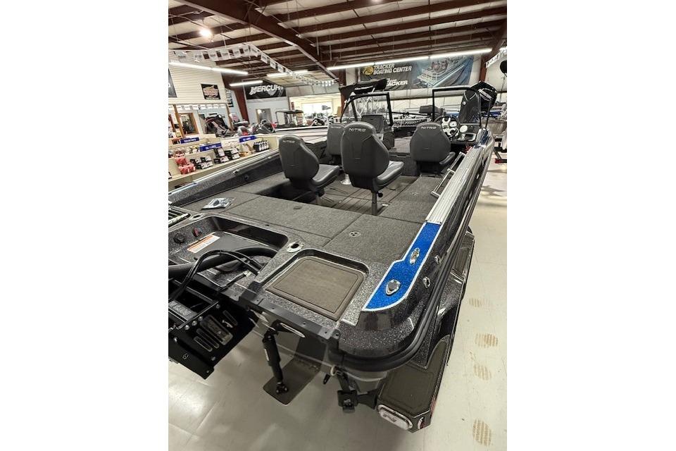 2024 Nitro ZV21 fishing boat interior with seating and storage in showroom.