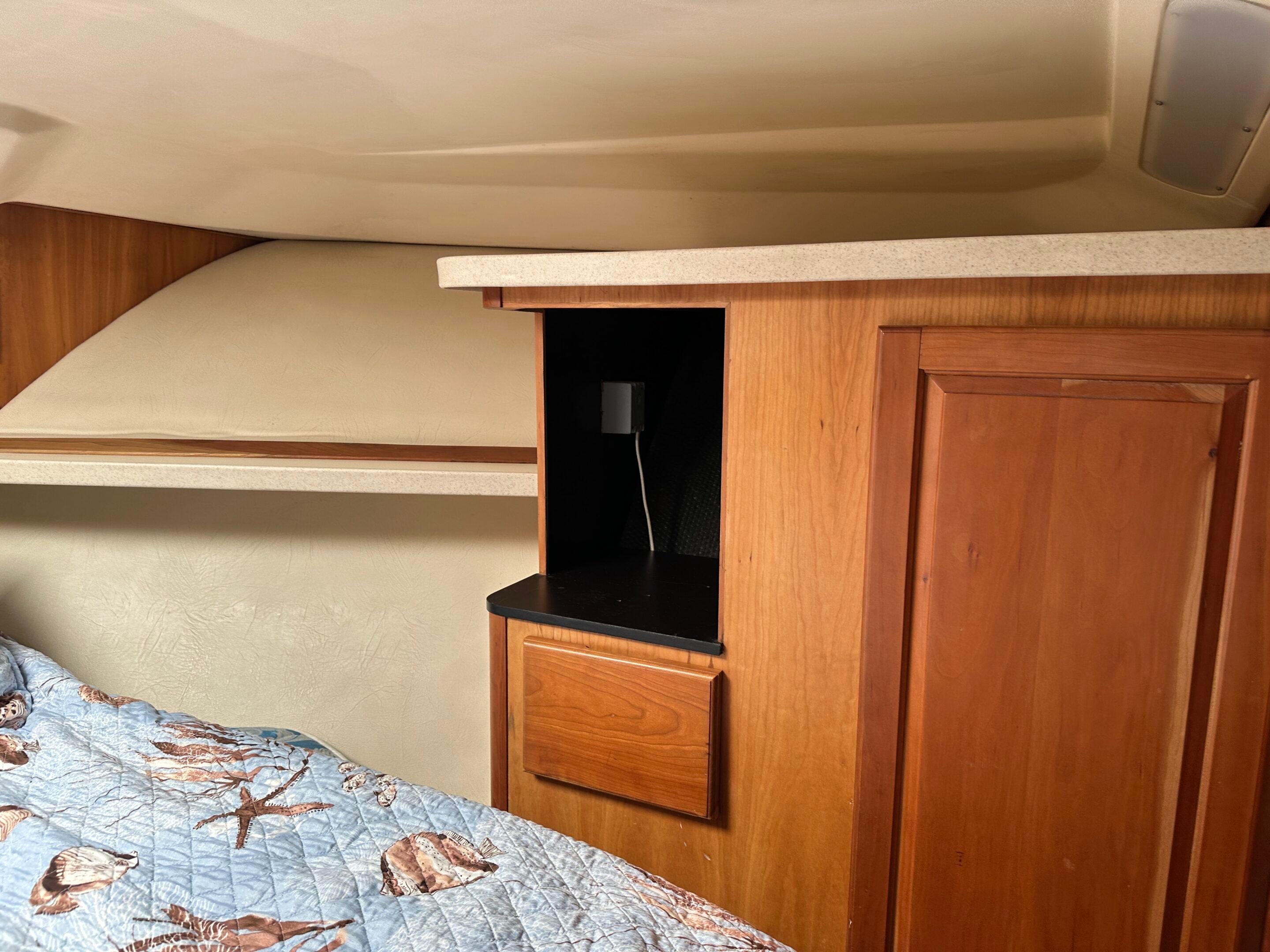 2003 Luhrs 40 Convertible cabin interior with wood cabinetry and bed.