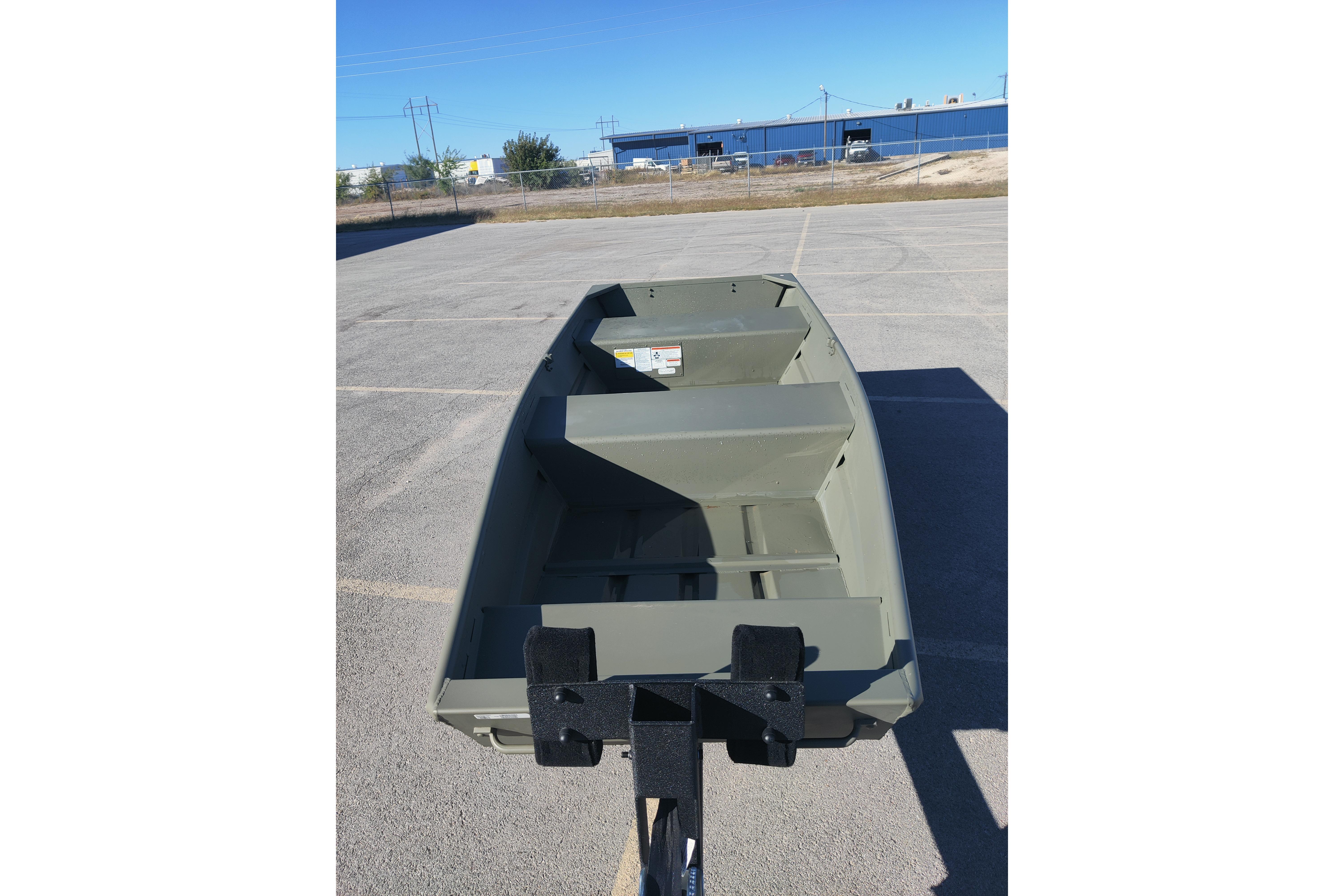 2026 Tracker Grizzly 12 Jon boat on trailer in parking lot.