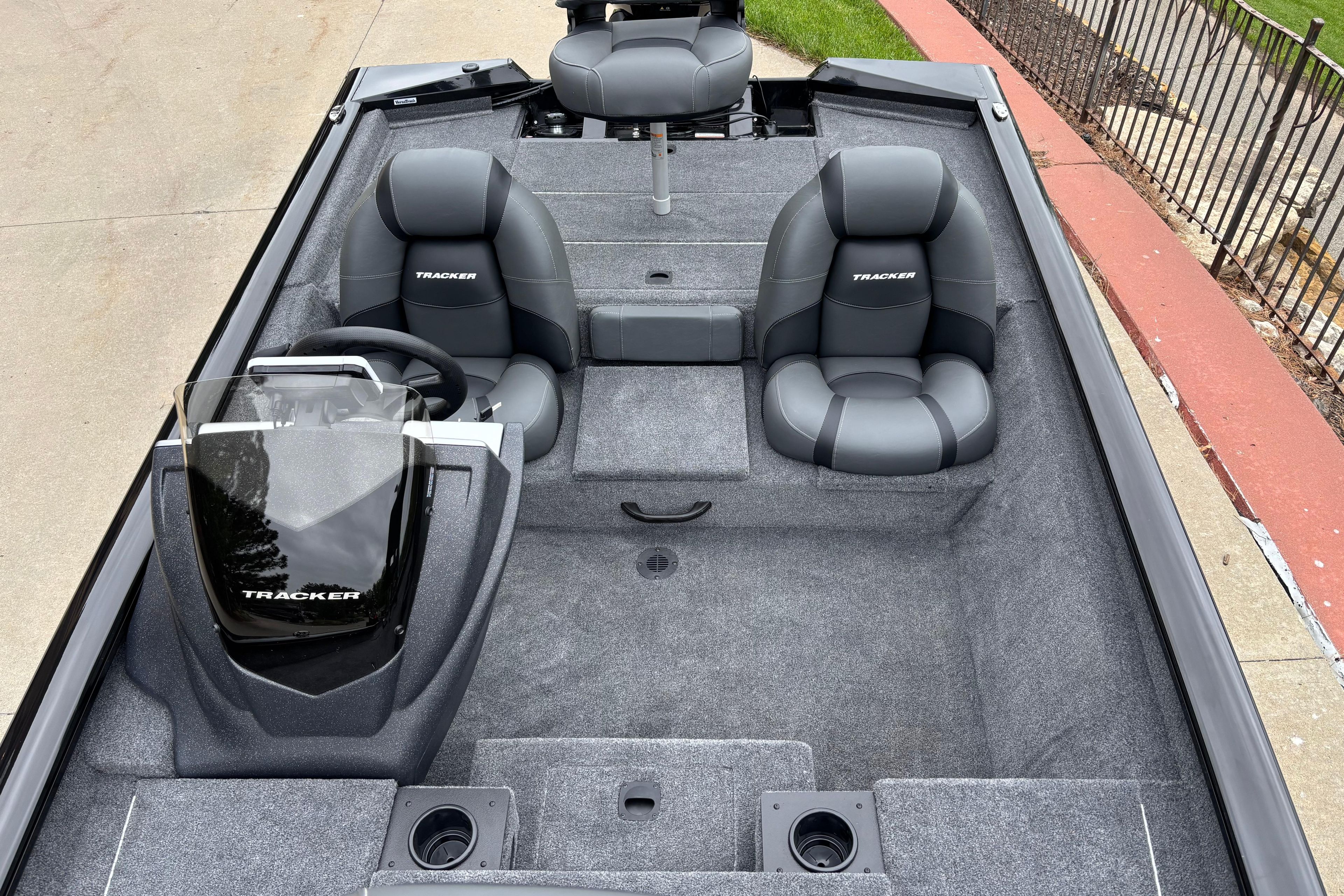 2026 Tracker Pro Team 175 boat interior with gray seating and steering console.