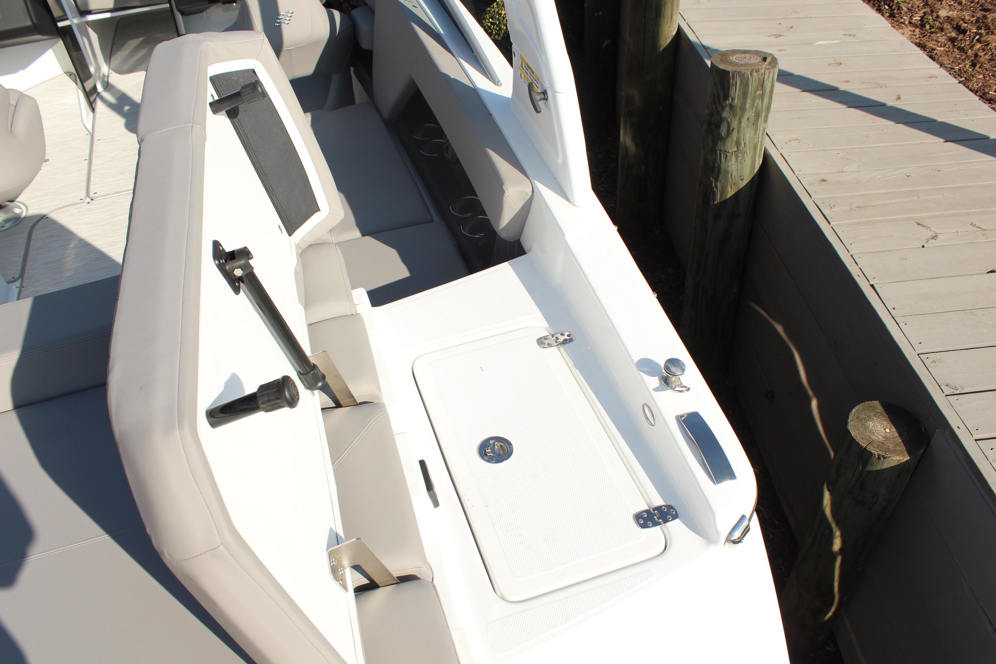 2026 Four Winns H4 boat interior with seating and storage compartment.