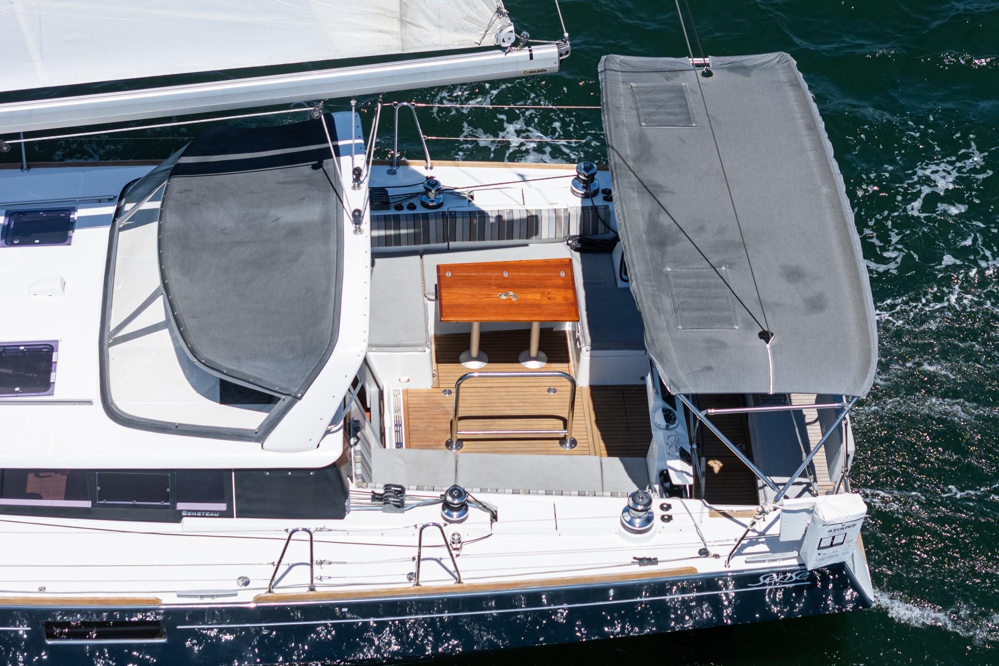 2017 Beneteau Sense 50 yacht with spacious deck and canopy, sailing on open water.