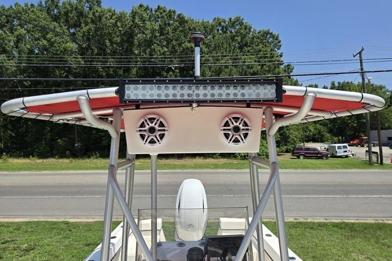 2000 May-Craft 2000CC boat with T-top, speakers, and LED light bar.