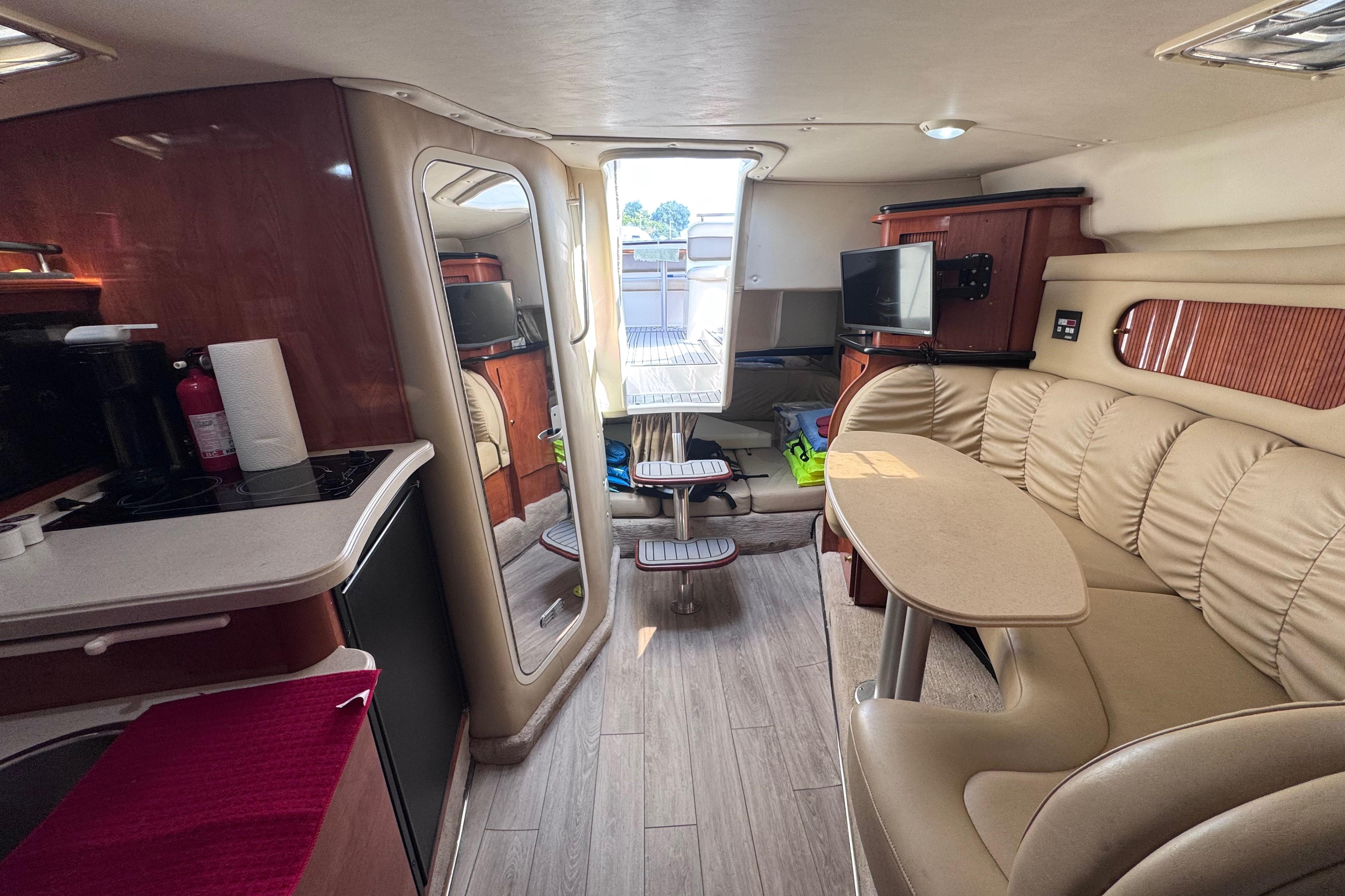 Interior of 2003 Rinker Fiesta Vee 312 boat with cozy seating and modern amenities.