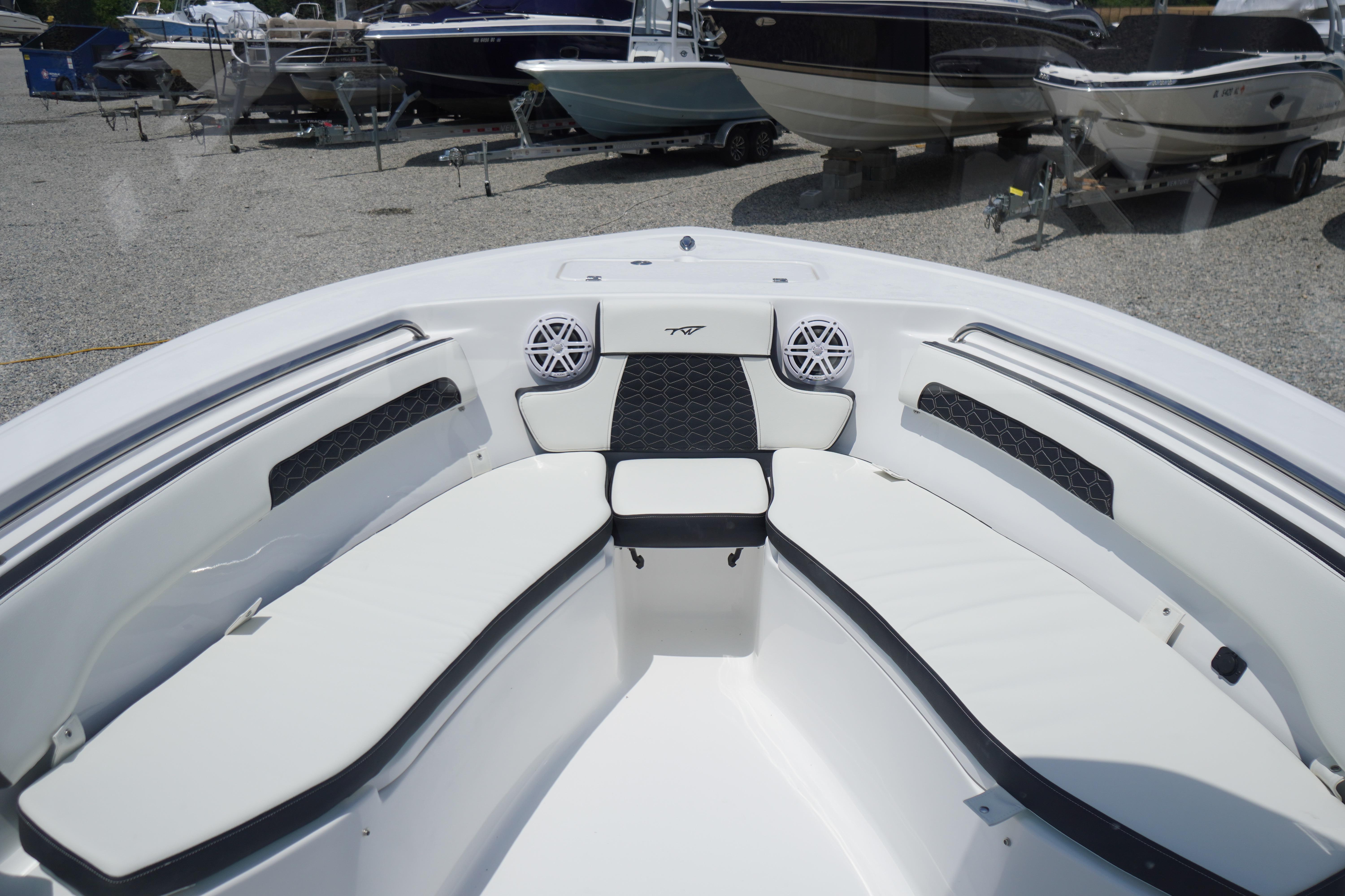2027 Tidewater 220 CC Adventure boat interior with white seating and speakers.