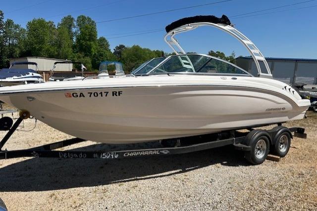 2023 Chaparral 23 SSi boat on trailer, parked outdoors on gravel.