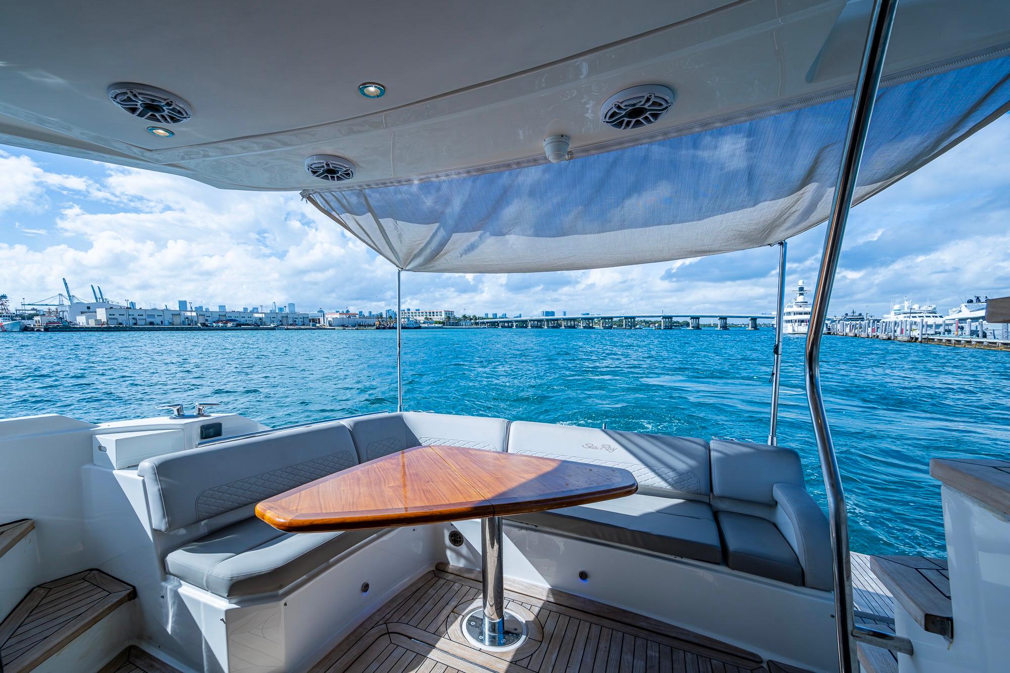 Luxurious 2018 Sea Ray L550 Fly yacht with elegant seating and ocean view.