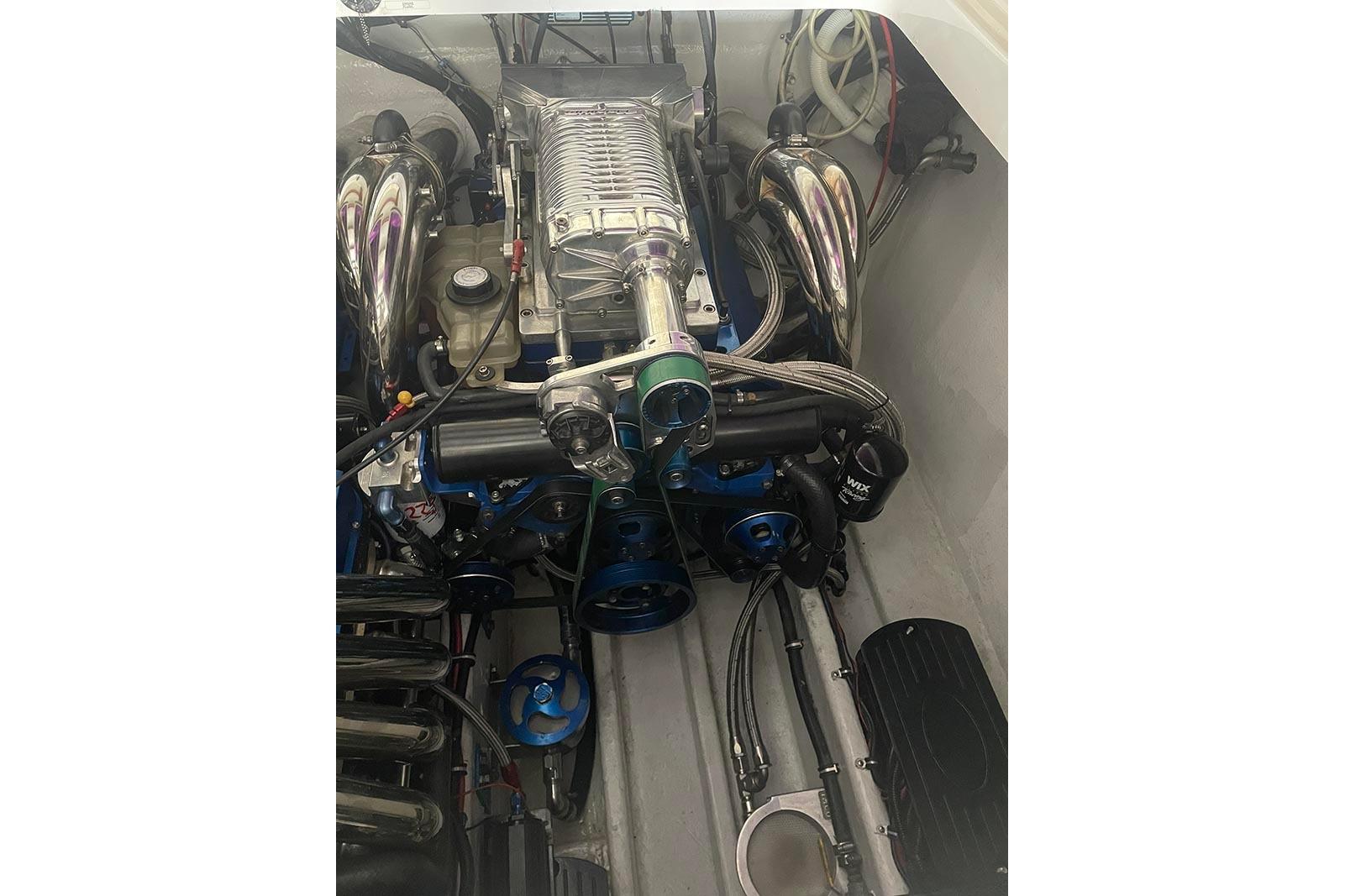 Engine of a 2004 Fountain 38 Lightning boat, showcasing chrome components and intricate detailing.