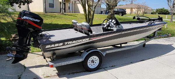 2004 Bass Tracker PRO TEAM 185 SE fishing boat on trailer with Mercury outboard motor.