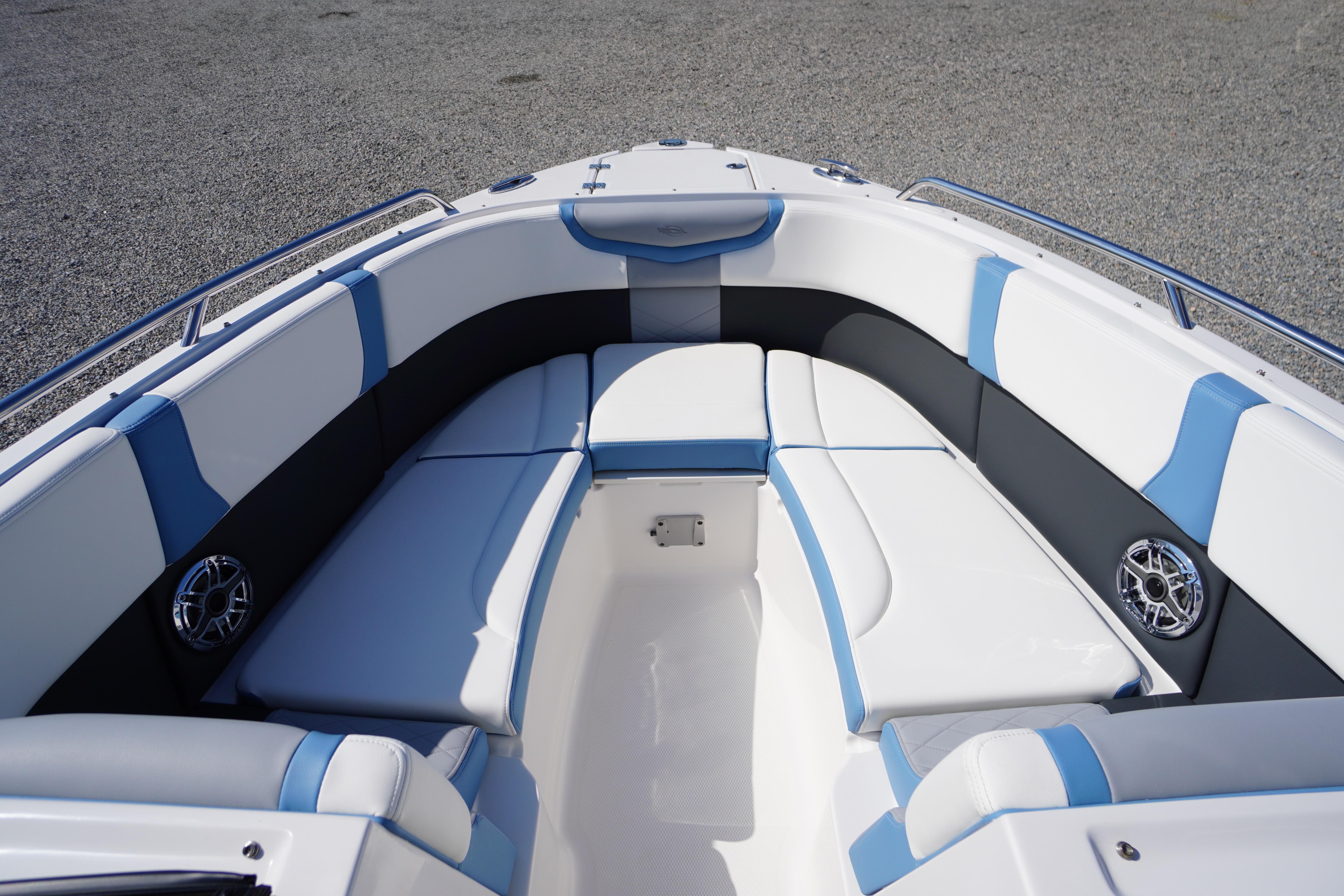 Luxurious seating area on the 2026 Chaparral 270 OSX boat, featuring blue and white upholstery.