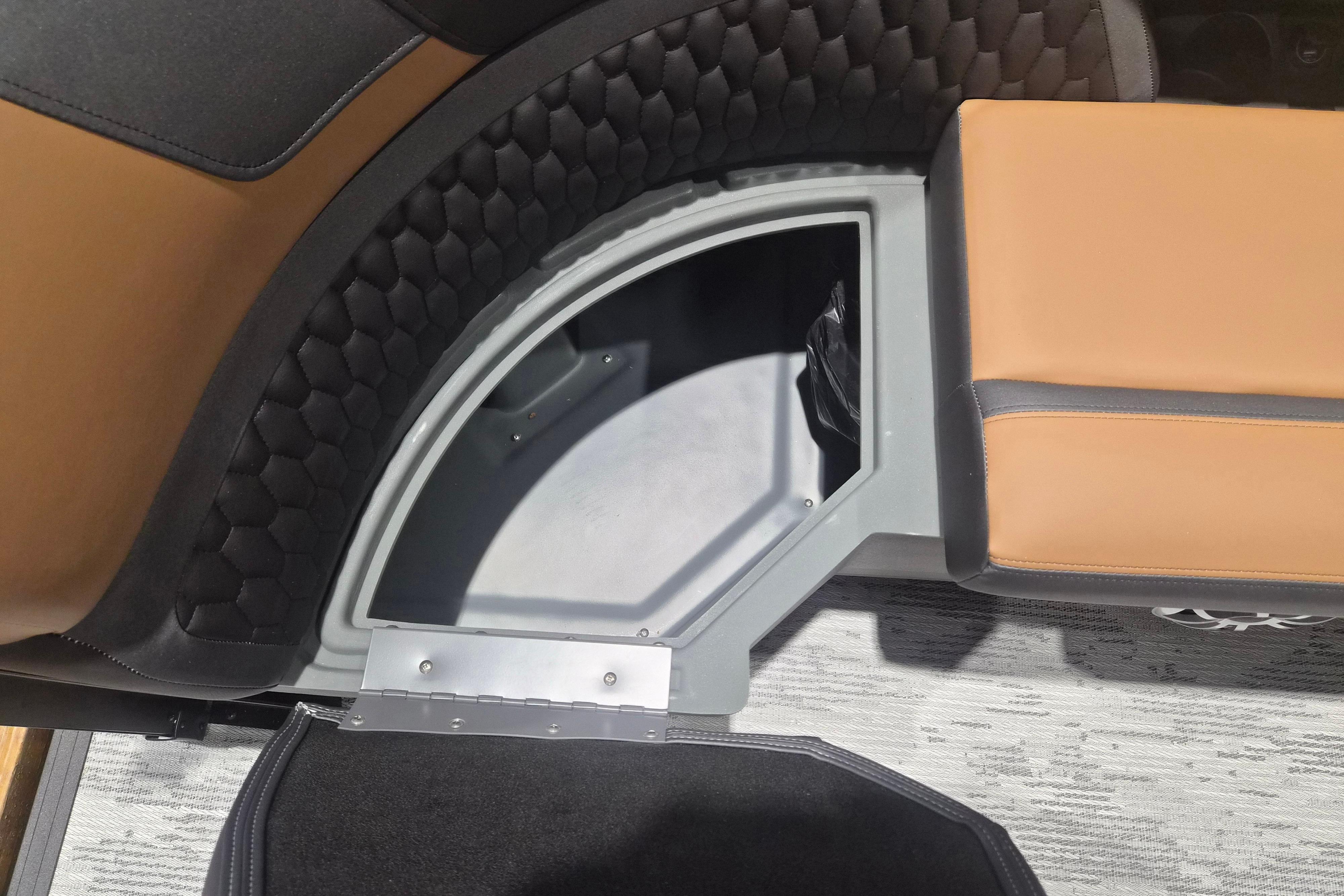 Interior storage compartment of 2026 Sylvan L3 SLZ boat with brown seating.