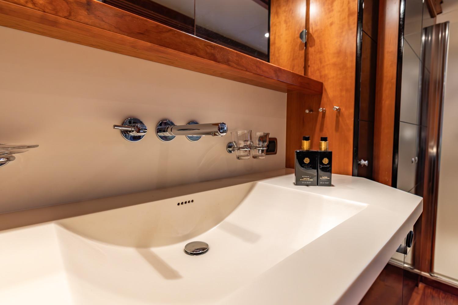 Luxurious bathroom sink in 2005 Van der Valk Continental 1900 yacht, featuring modern fixtures.