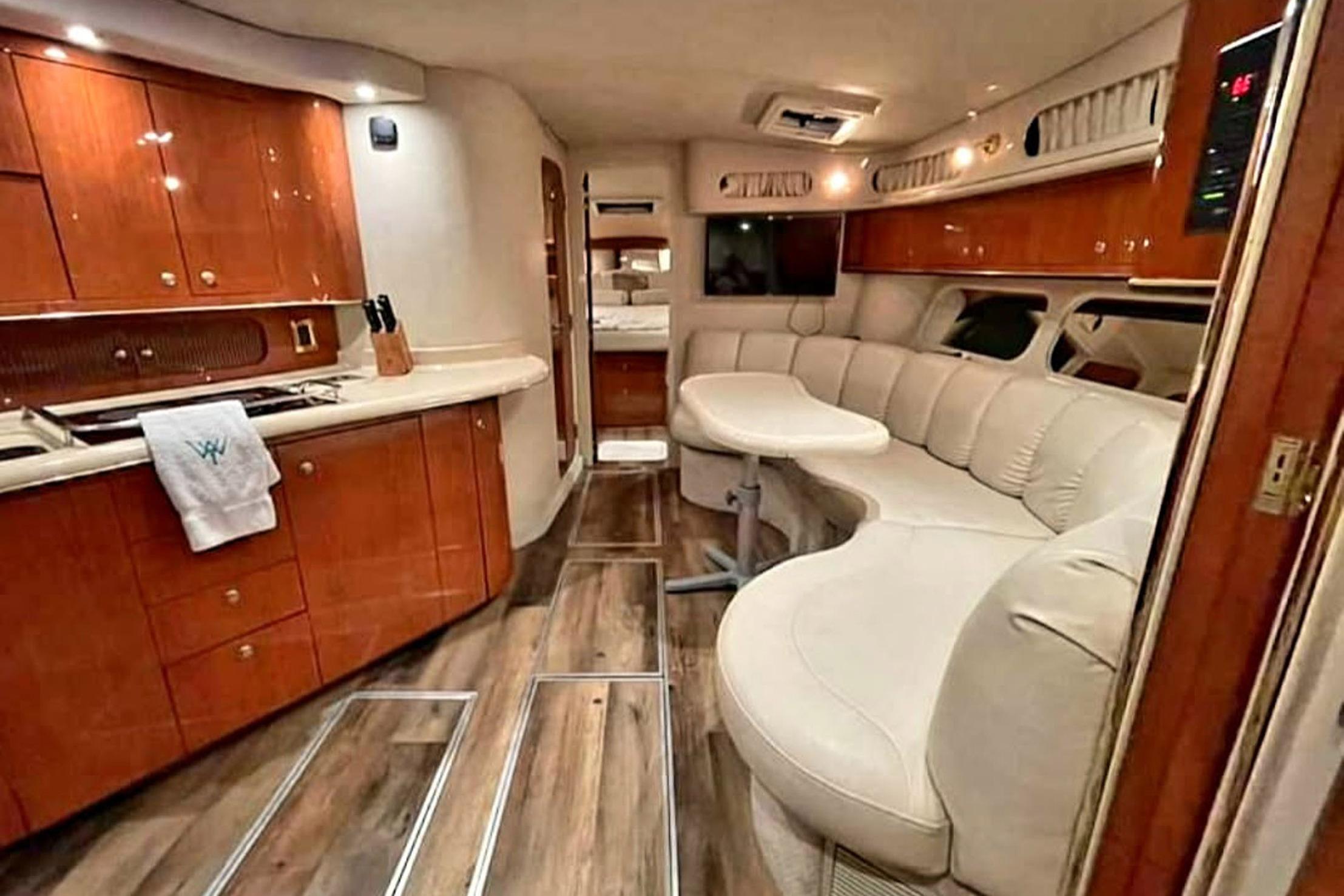 Luxurious interior of a 1998 Sea Ray Sundancer 400 yacht with elegant wood finishes.