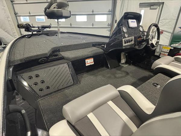 2025 Nitro Z18 boat interior with steering console and seating in a garage setting.
