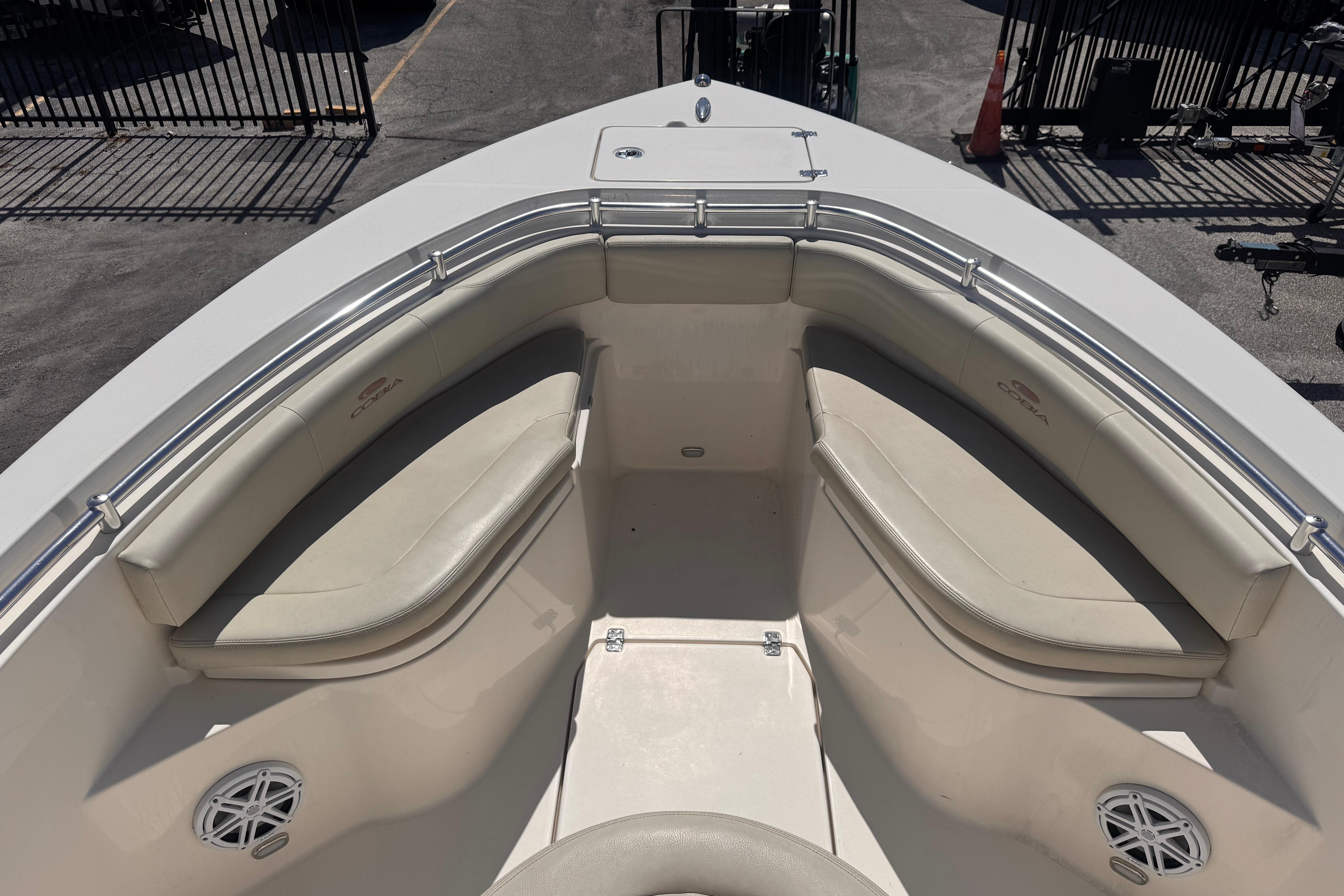 2023 Cobia 237 Center Console boat interior with cushioned seating and stainless steel railings.
