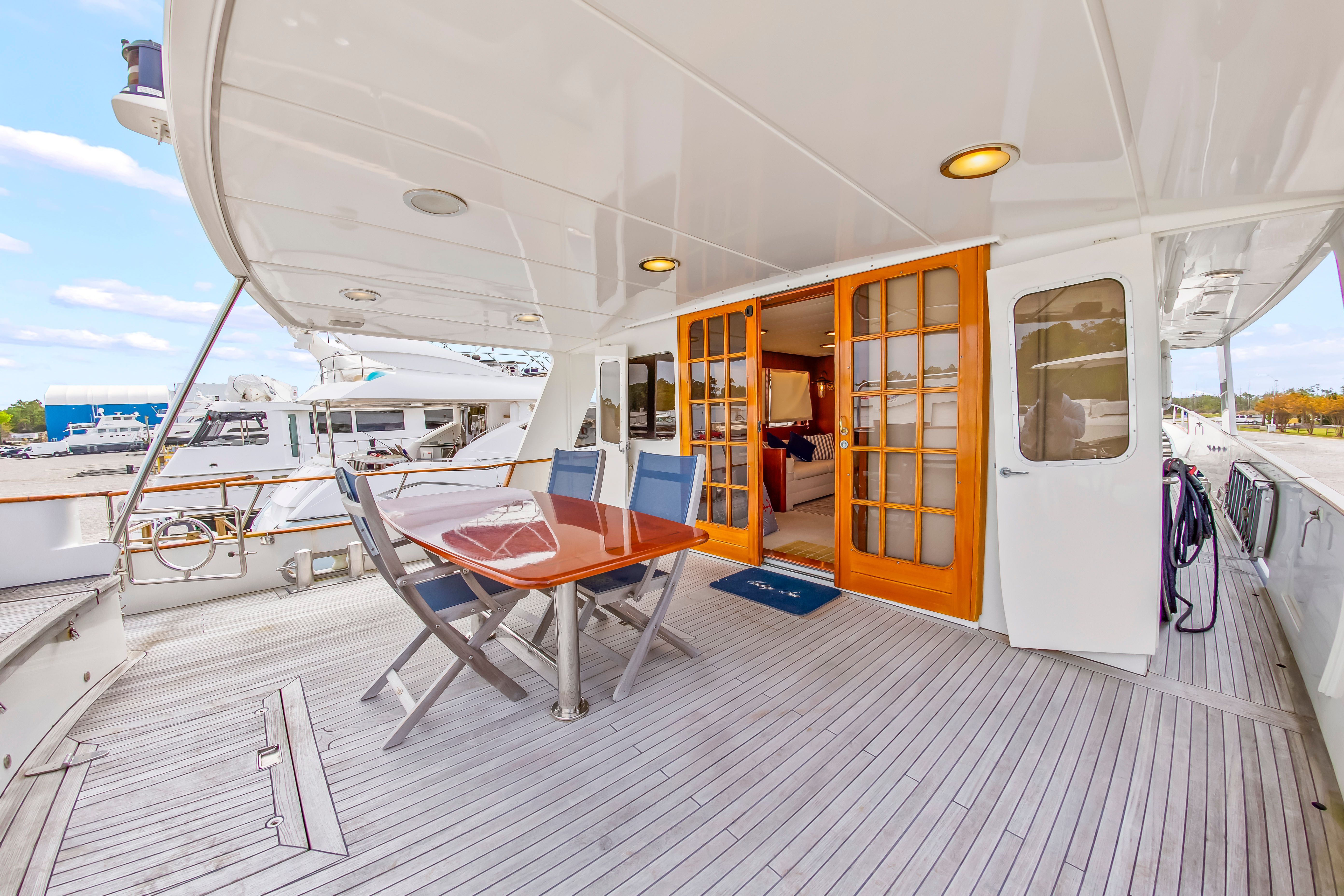 Deck of a 1987 Jongert 78 Motor Yacht with table and chairs.