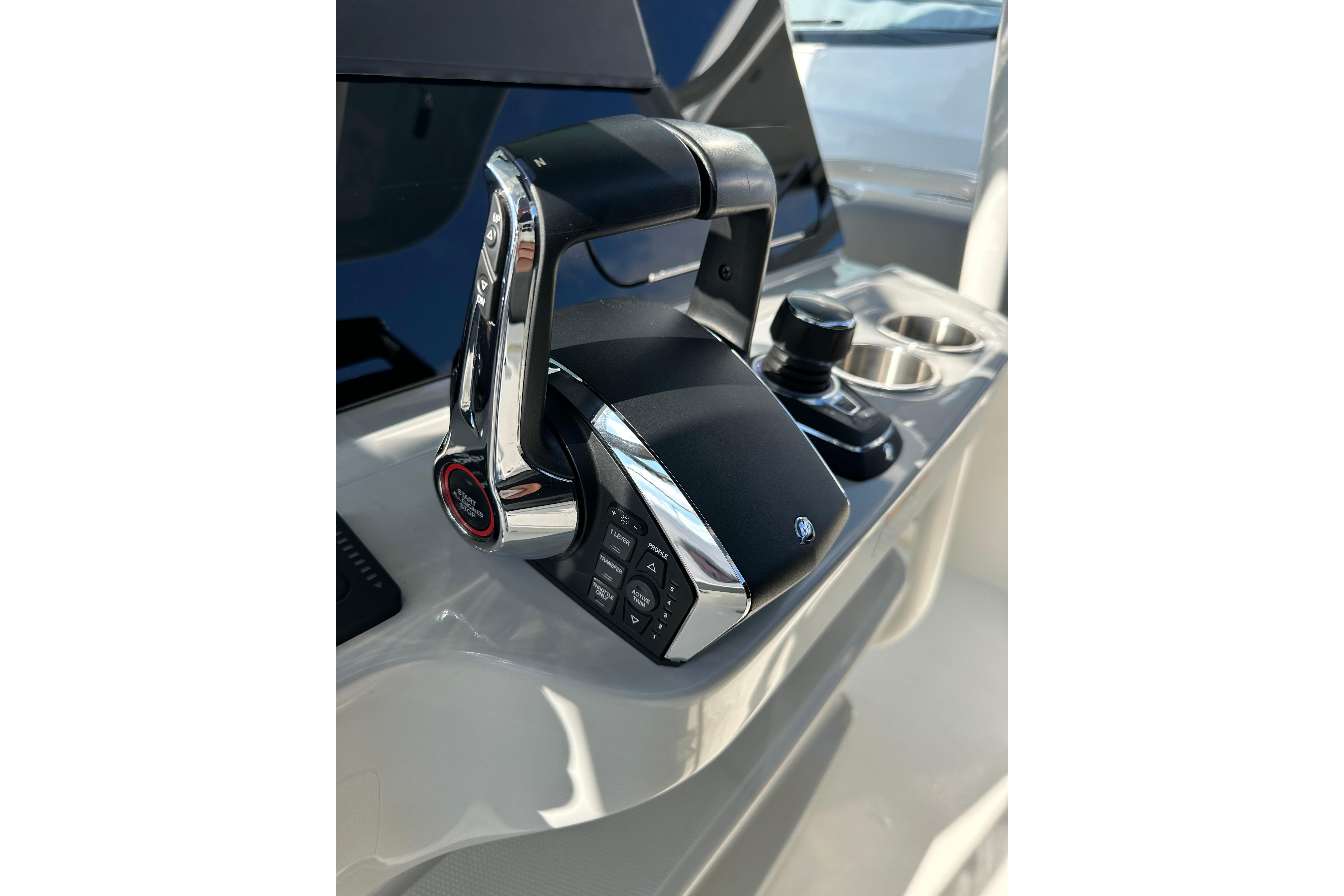Control panel of 2023 Boston Whaler 330 Outrage boat, featuring modern throttle and joystick.