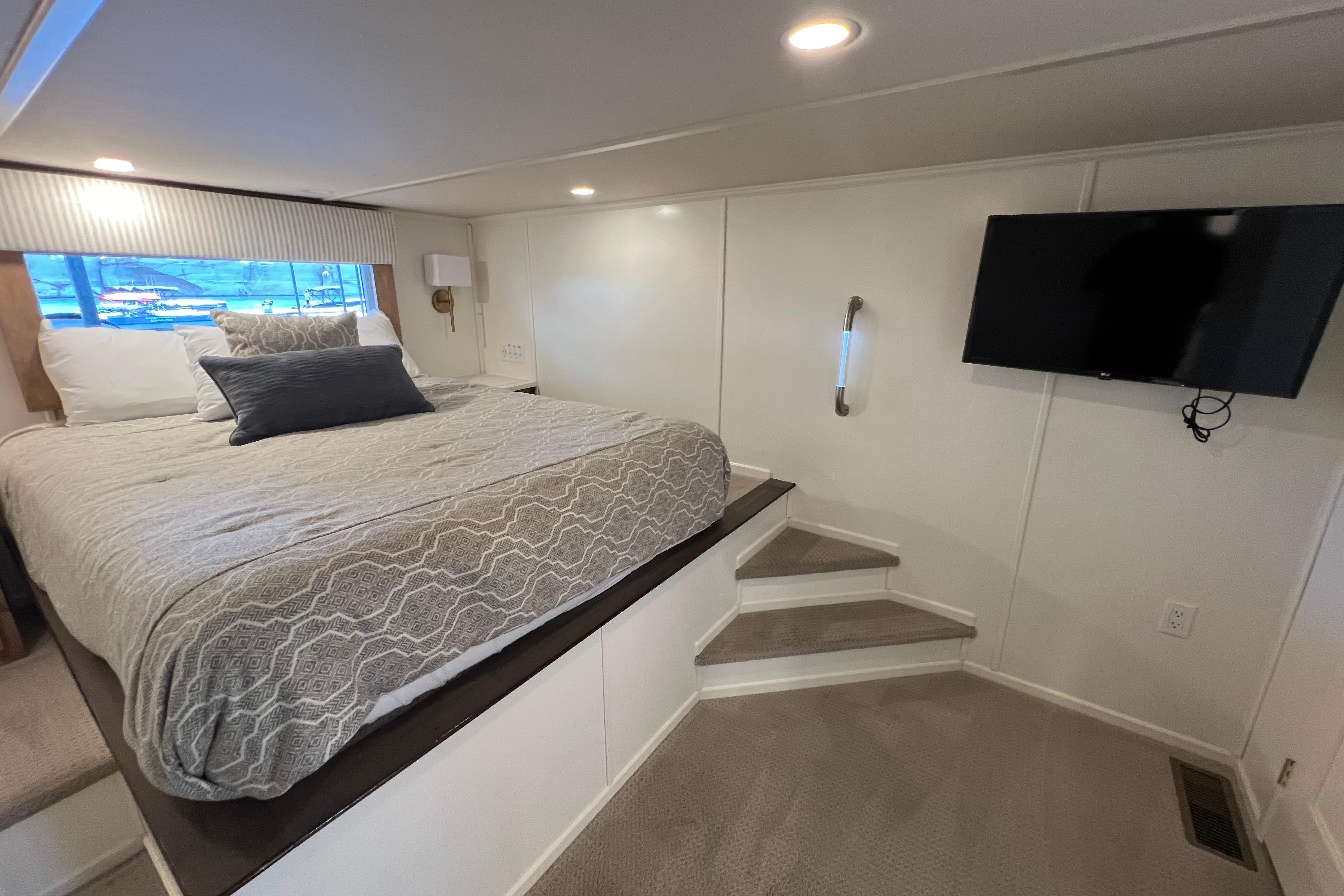 Luxurious bedroom in 2025 Sumerset Excellence Multiple Shares houseboat with modern decor and TV.