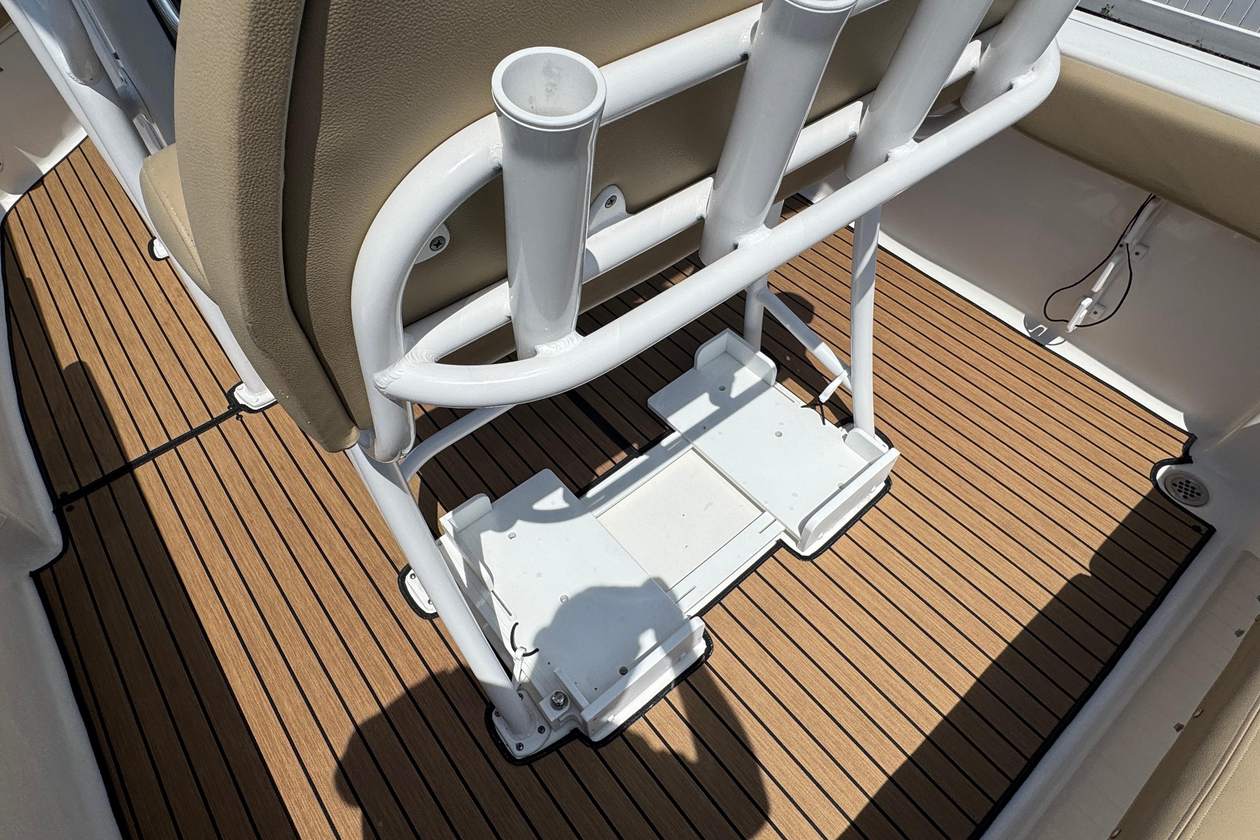 2016 Tidewater 230 LXF boat interior with rod holders and teak-style flooring.
