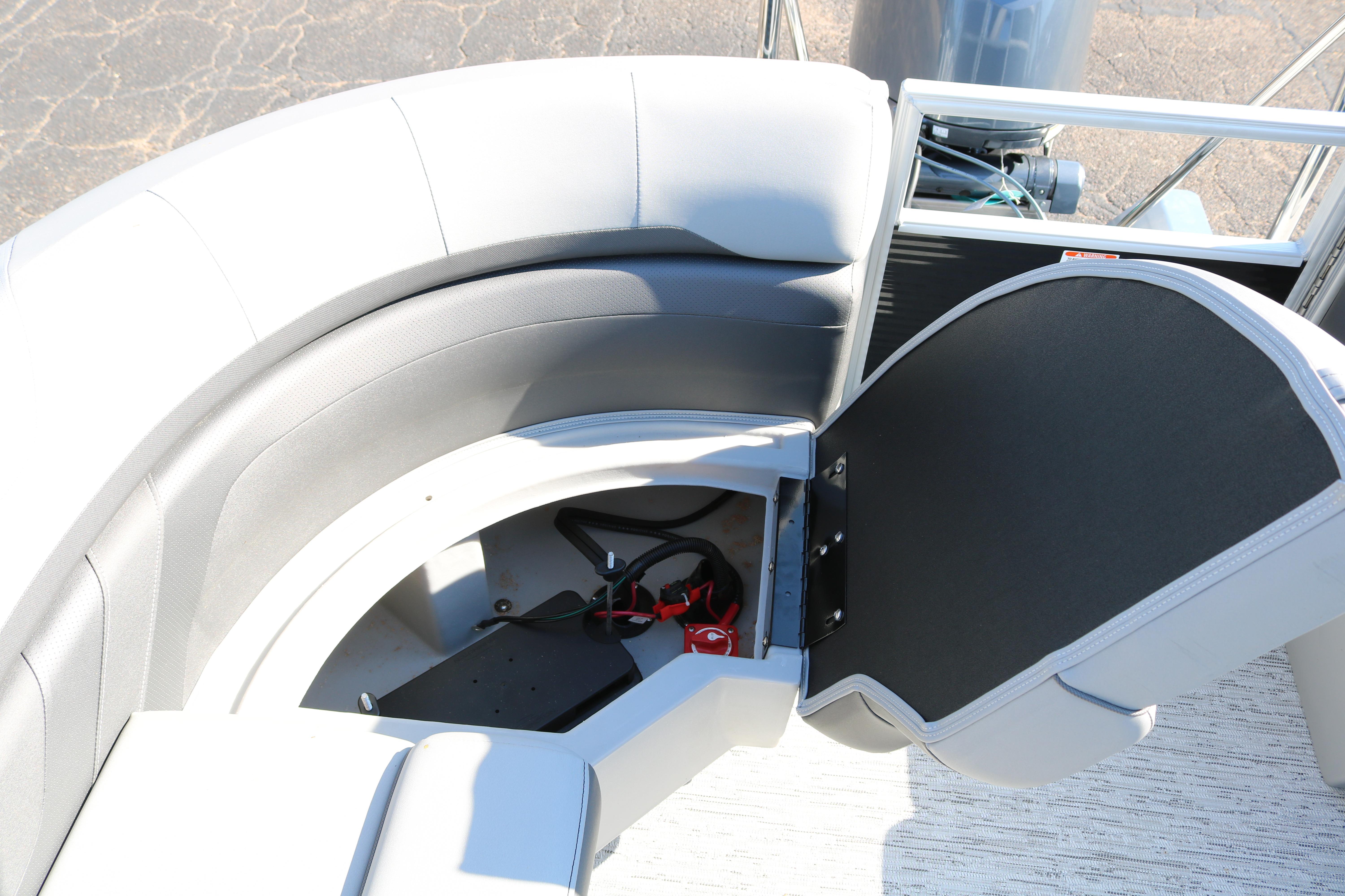 2026 Bennington 22SX Stern Radius boat with open storage compartment and seating.