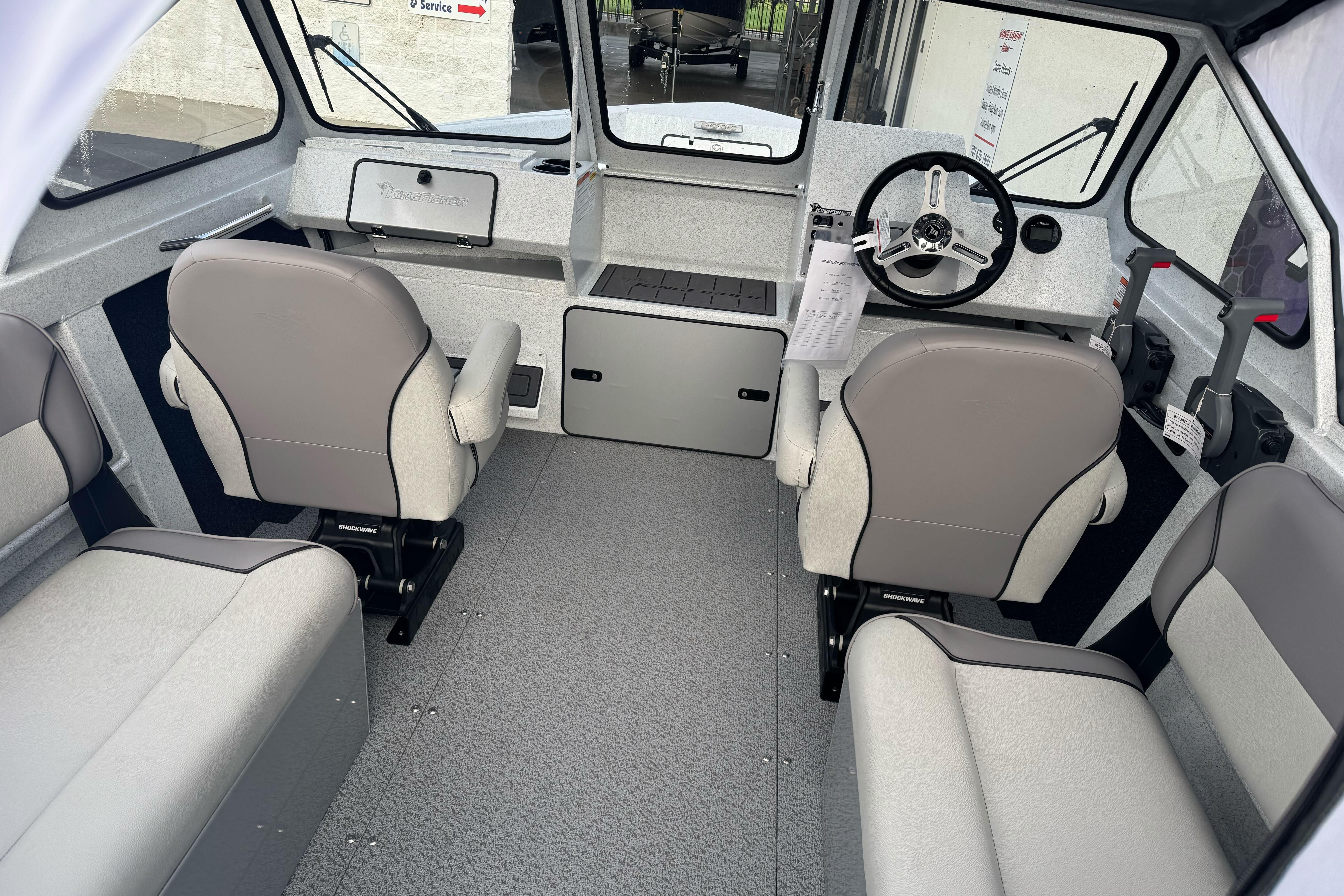 Interior of 2026 KingFisher 2025 Escape boat with modern seating and steering wheel.