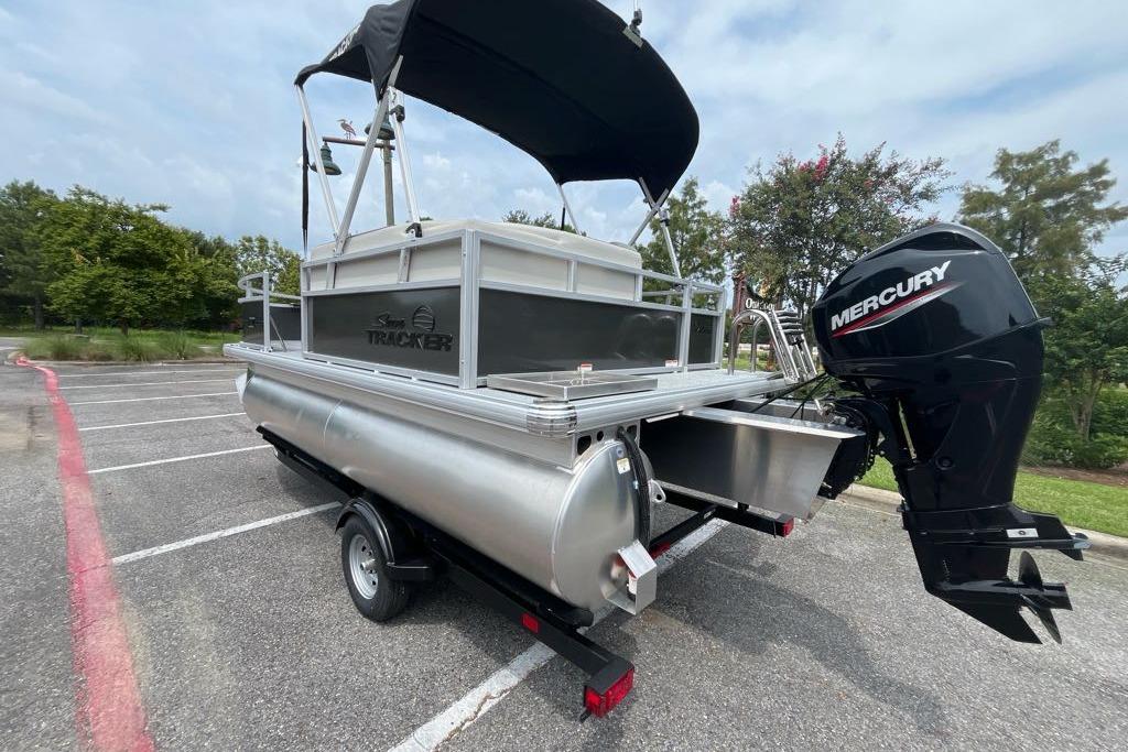 2026 Sun Tracker Bass Buggy 16 XL Select pontoon boat with Mercury outboard motor.