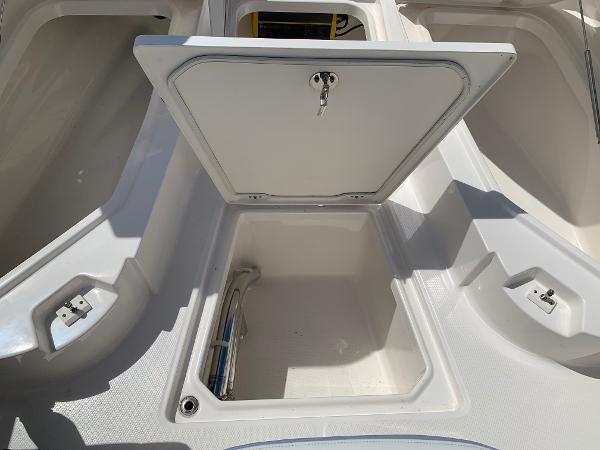 2024 Robalo 266 Cayman storage compartment with open hatch.