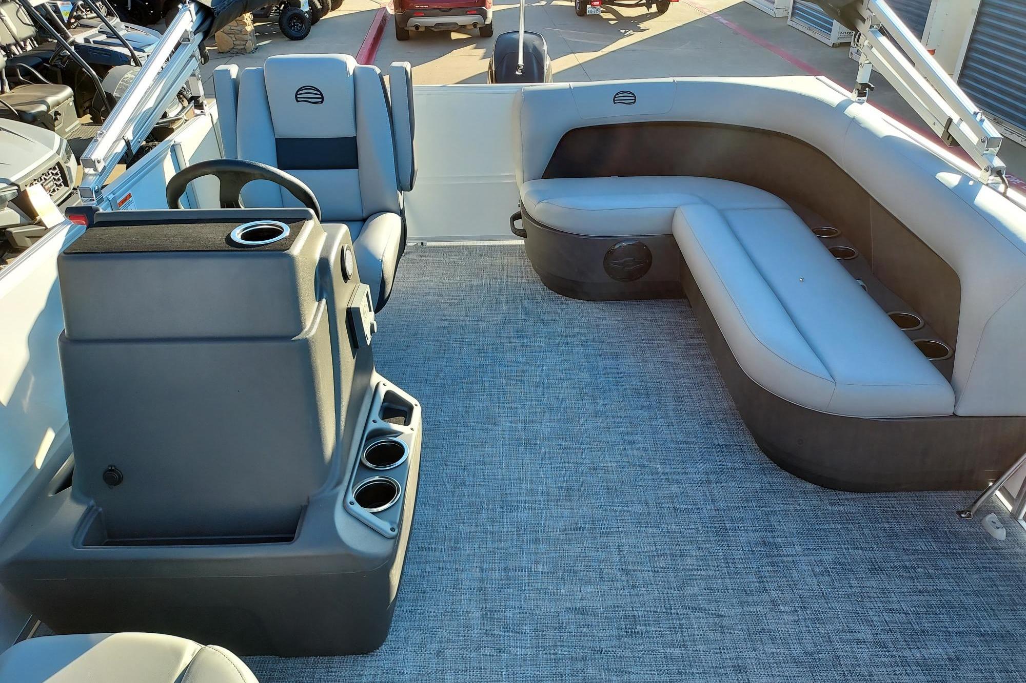 2026 Sun Tracker Party Barge 16 DLX interior with seating and steering console.