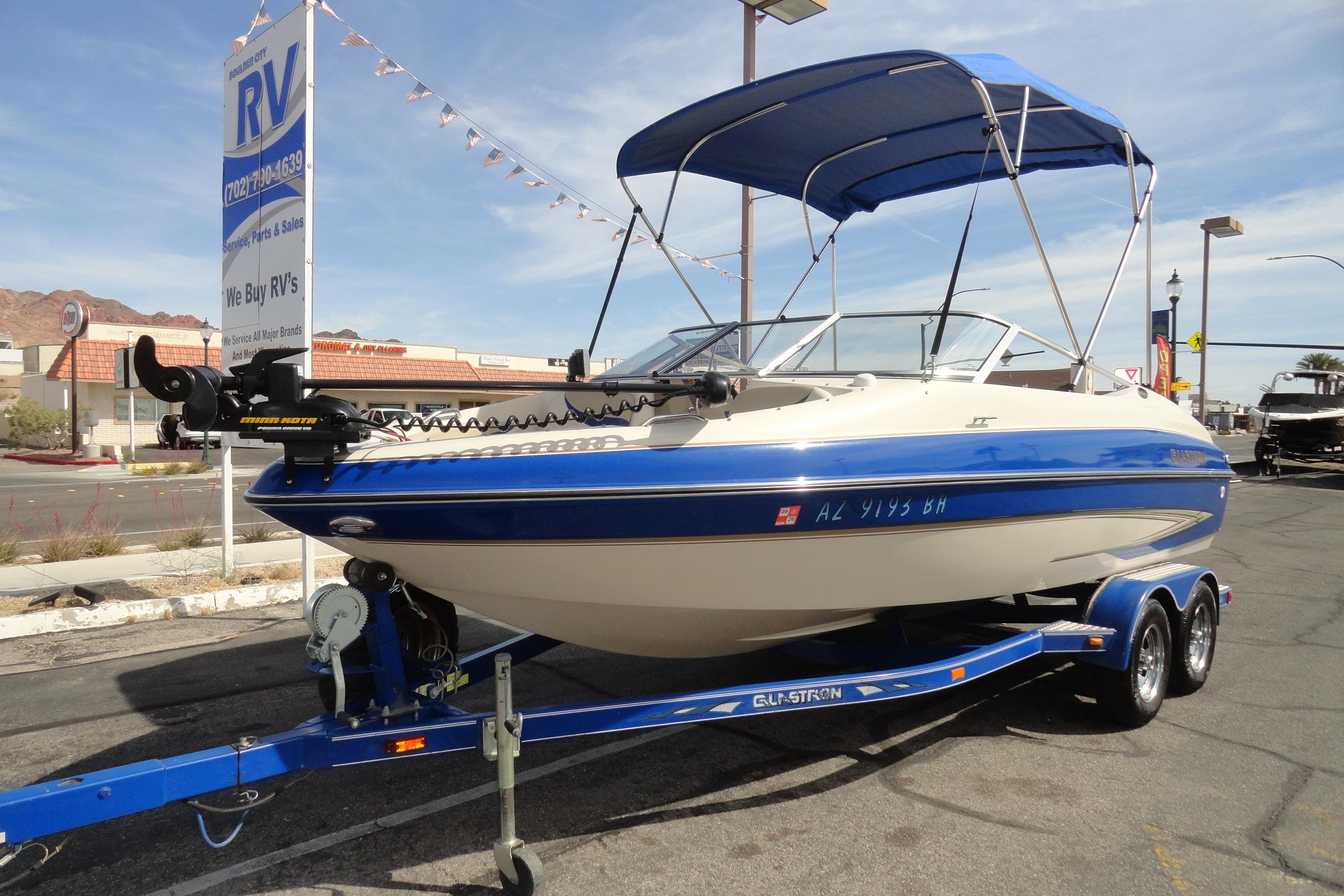 2004 Glastron GX 205 Ski & Fish boat with blue canopy on trailer.