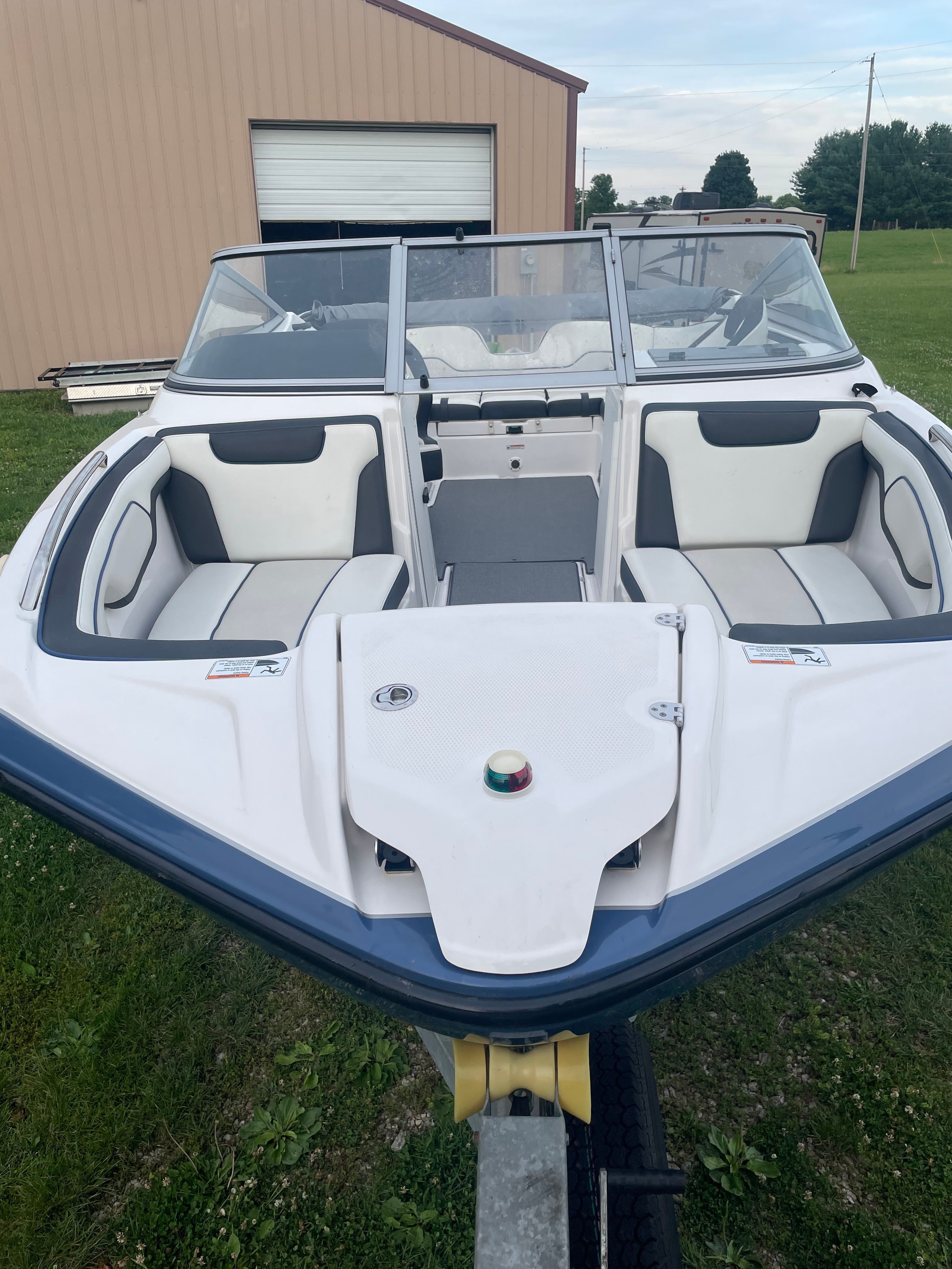 Yamaha SX210 2019 on a trailer, featuring white and black interior, in front of a building.