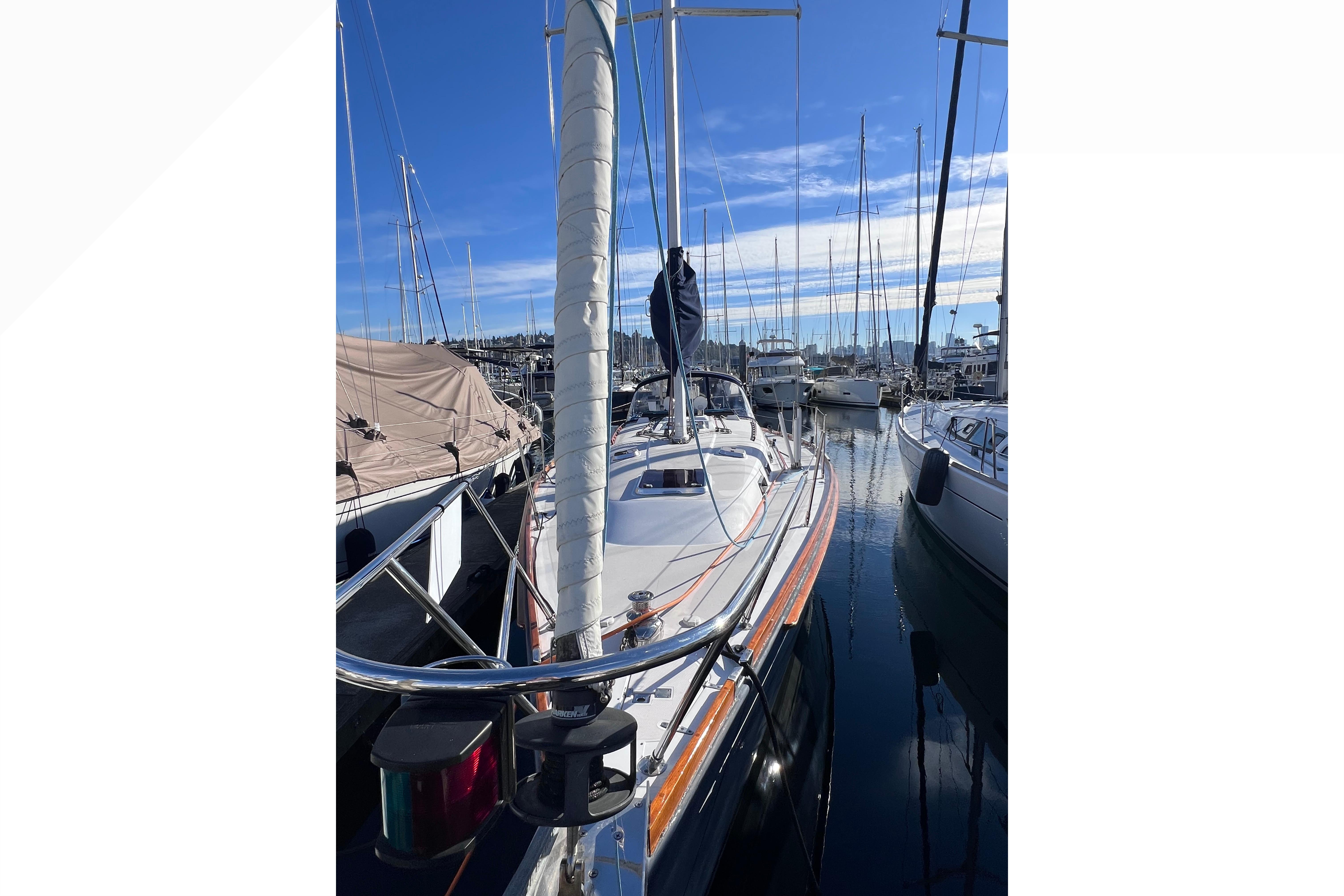 2006 Sabre 426 sailboat docked in a marina under a clear blue sky.
